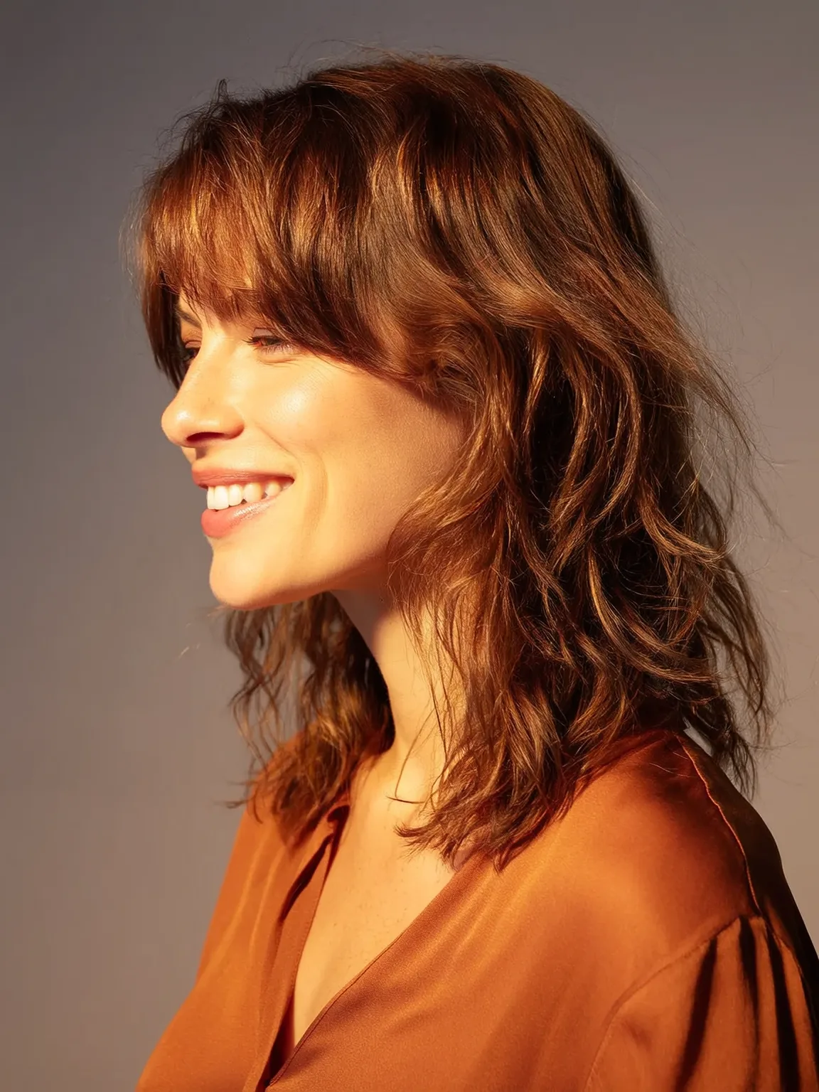 Shoulder-Length Warm Copper Brown Shag with Wispy Bangs