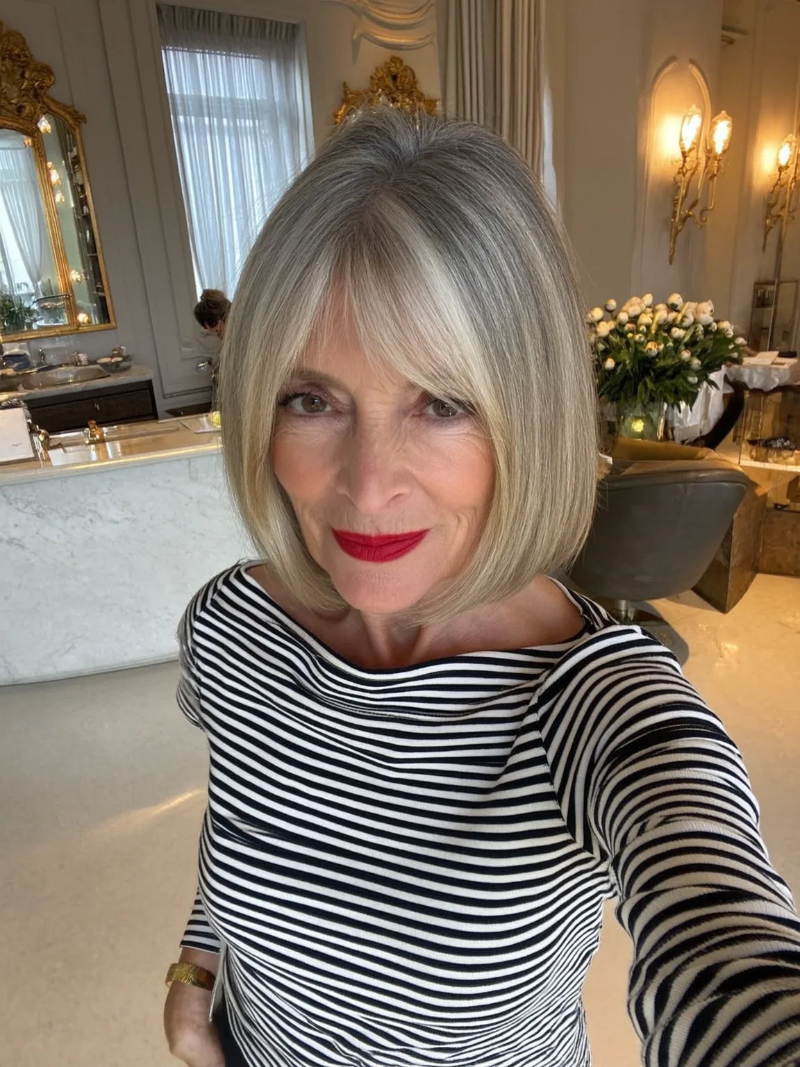 Silvery Ash Blonde Bob with Curtain Bangs and Sleek Texture