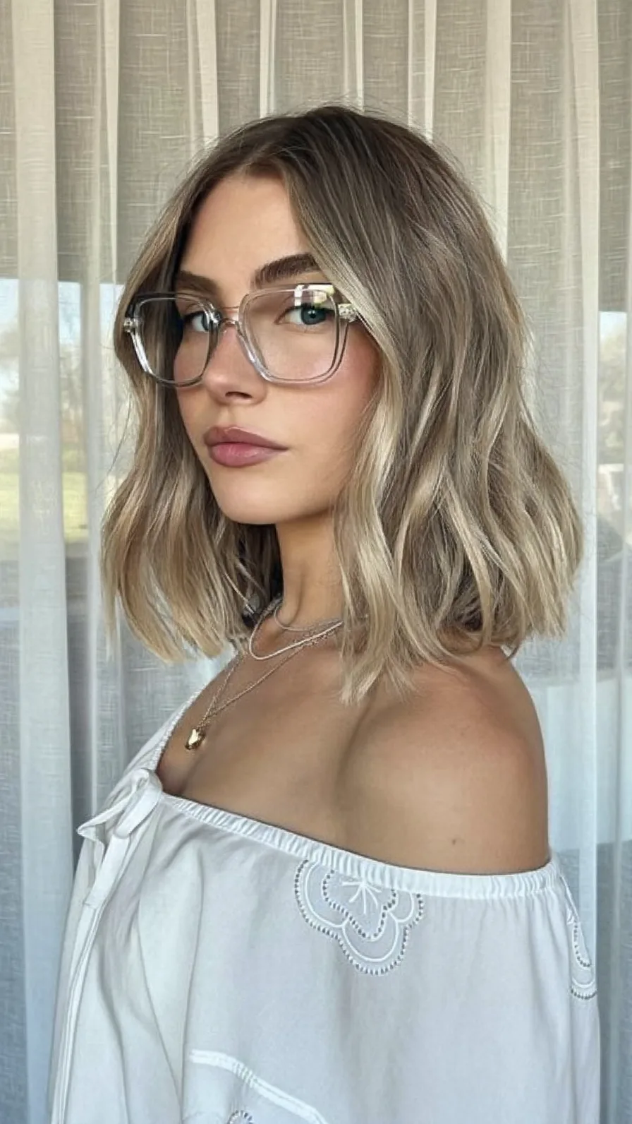 Soft Ash Blonde Balayage Lob with Flowing Curtain Bangs