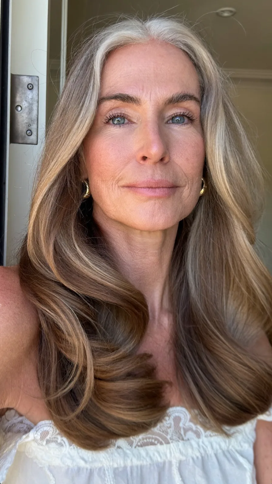 Voluminous Ash Blonde Long Layers with Natural Silver Roots