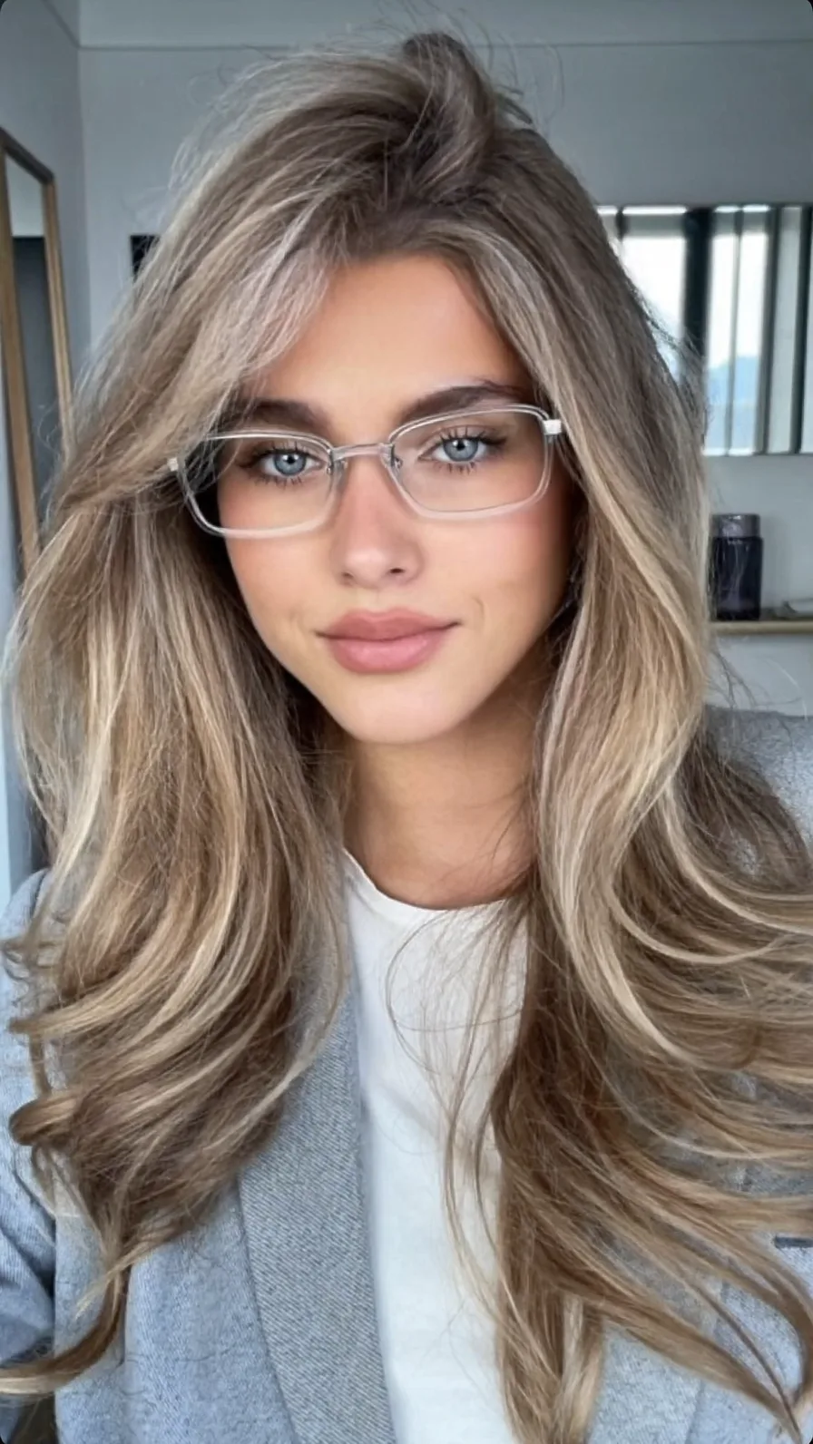 Voluminous Ash Blonde Long Layers with Side-Swept Bangs