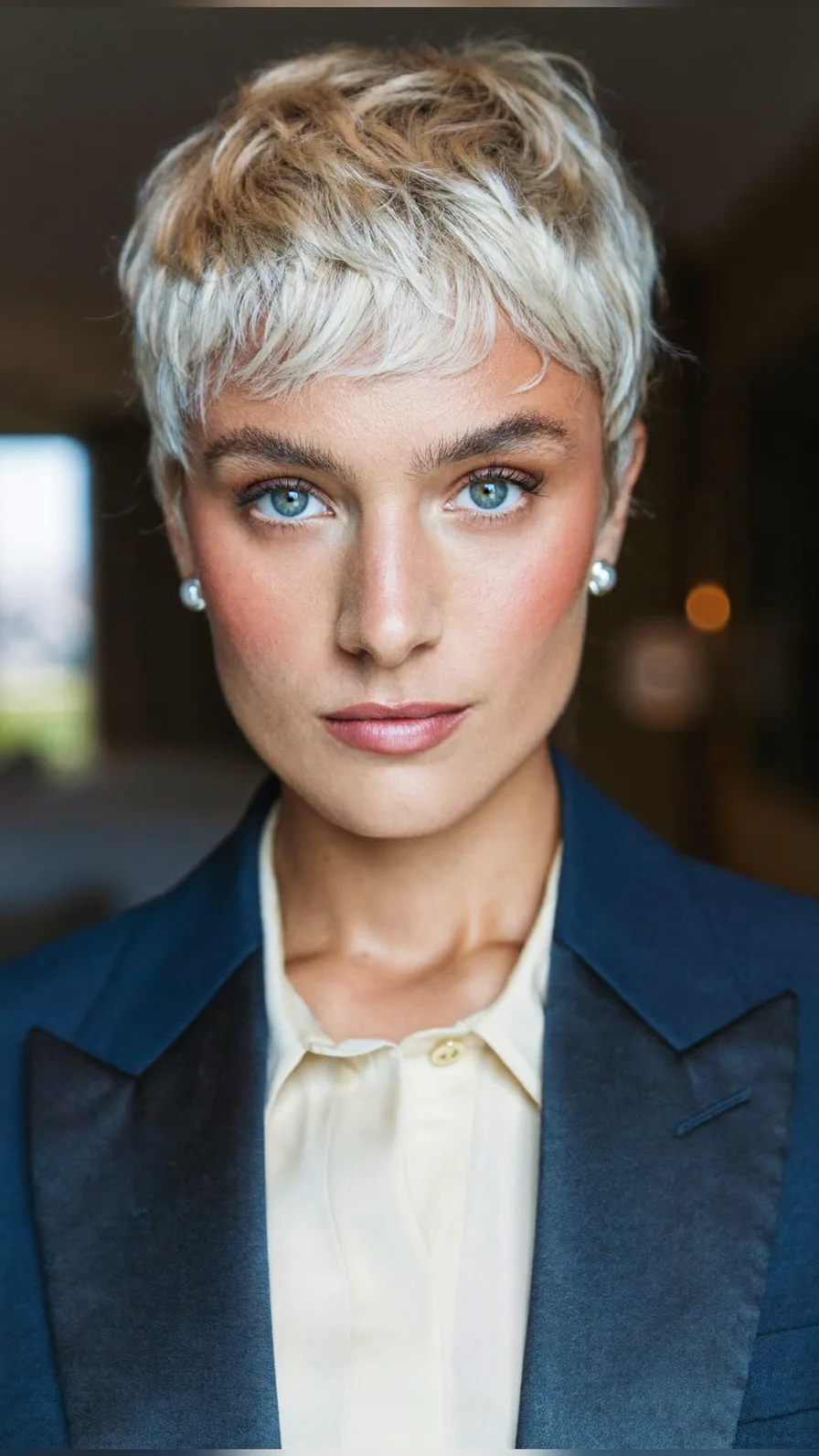 Textured Platinum Blonde Pixie Cut with Wispy Bangs