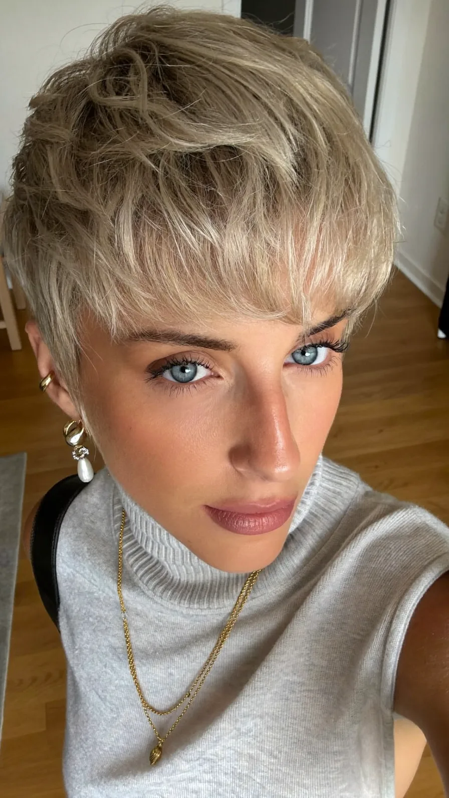 Textured Wavy Ash Blonde Pixie Cut with Wispy Bangs