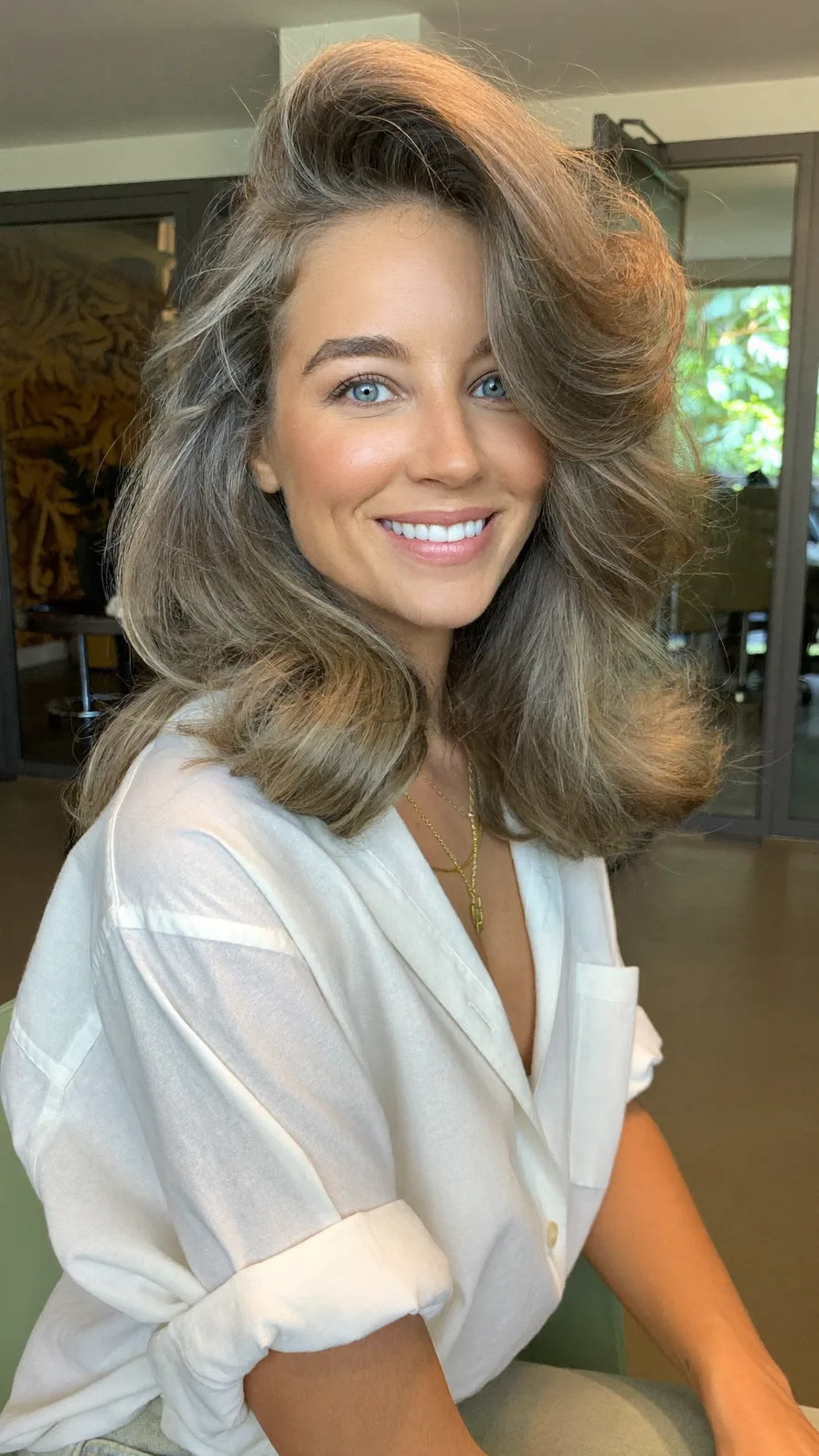 Voluminous Shoulder-Length Layered Blowout with Side-Swept Bangs