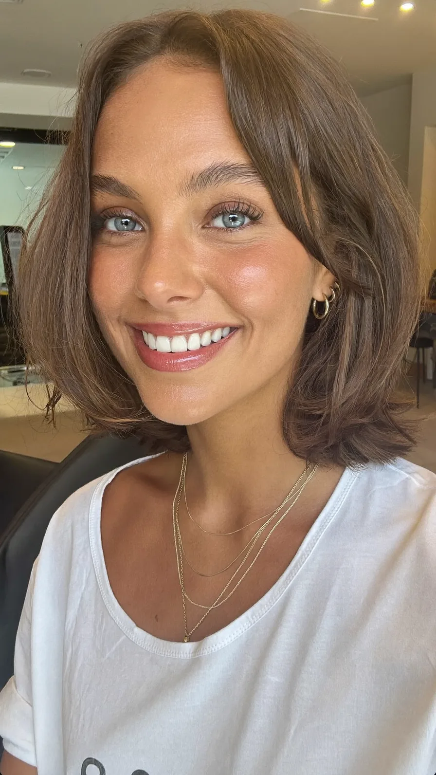 Modern Chin-Length Layered Haircut with Flowing Curtain Bangs