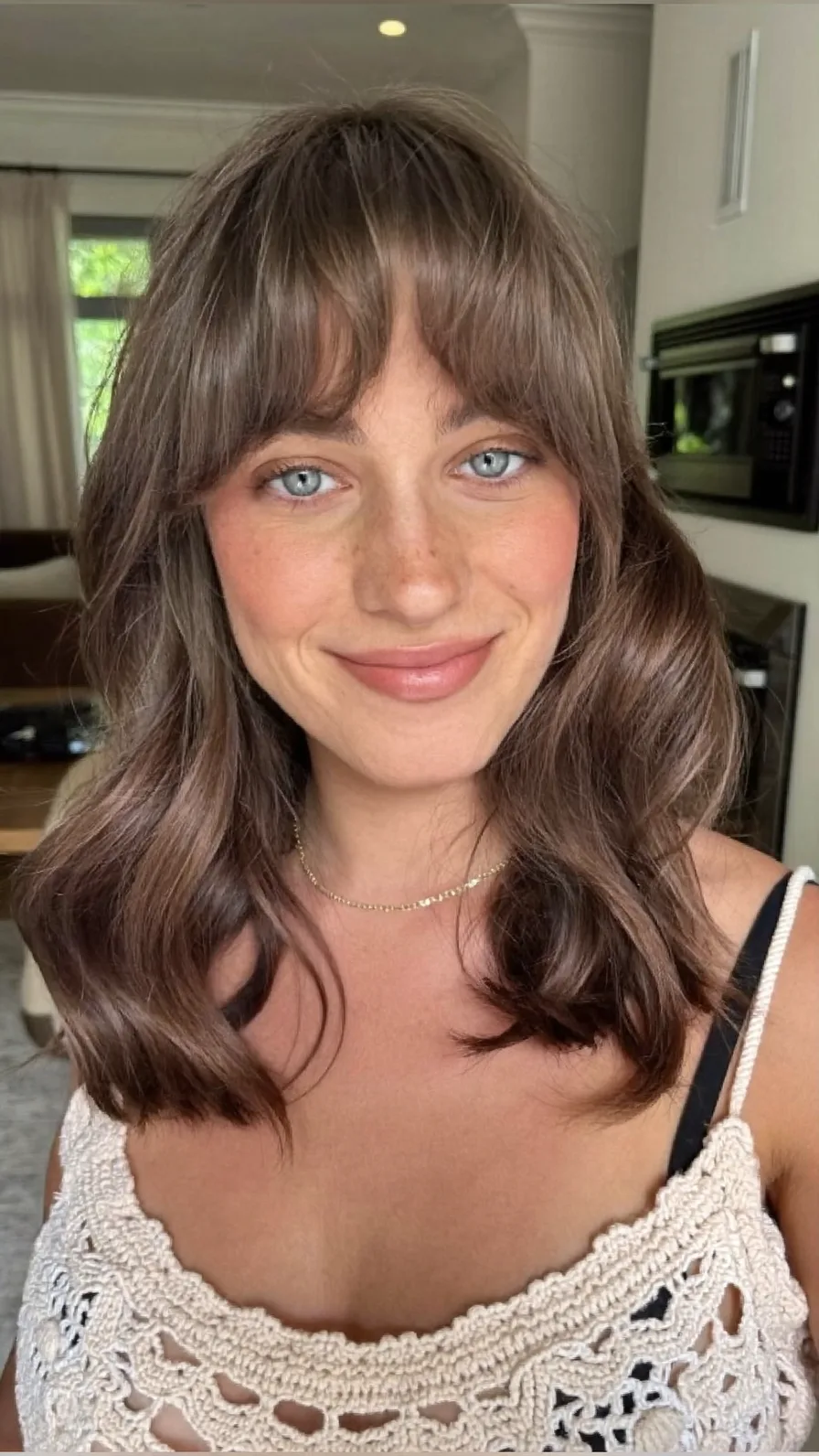 Soft Shoulder-Length Layers with Flowing Curtain Bangs Style
