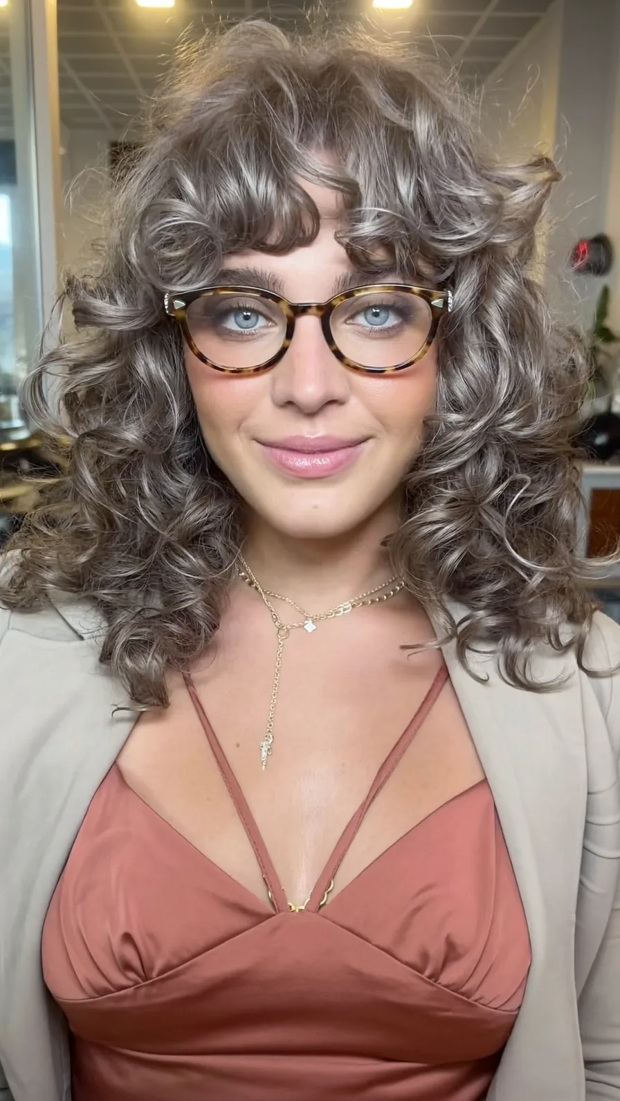 Voluminous Shoulder-Length Curly Hair with Ash Brown Highlights