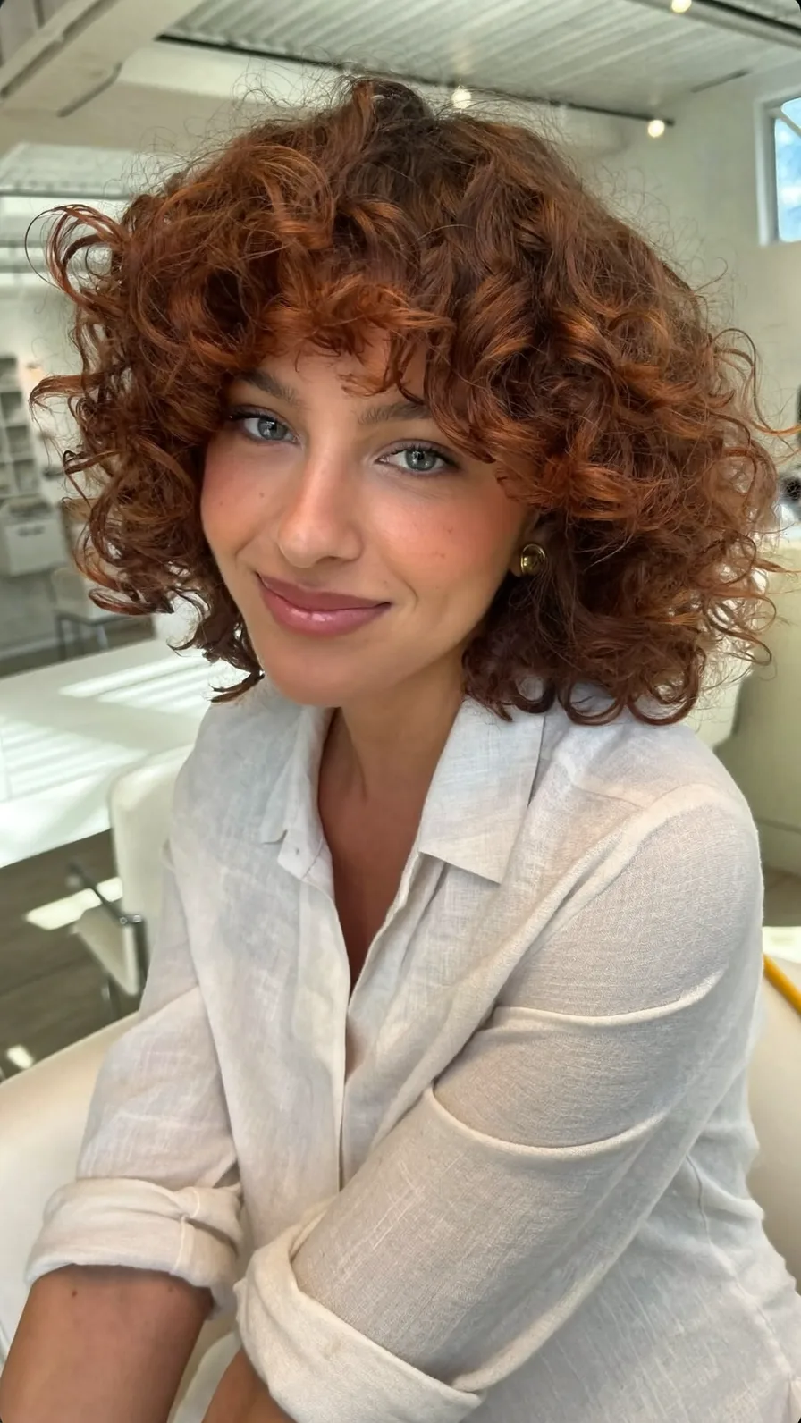 Voluminous Curly Auburn Bob with Soft Curtain Bangs
