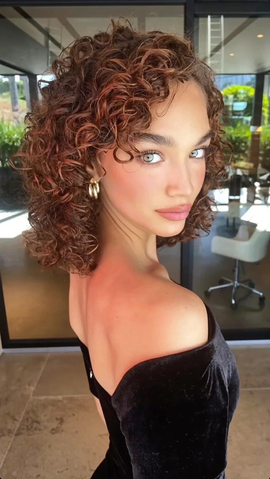 Voluminous Curly Bob with Rich Auburn Copper Tones