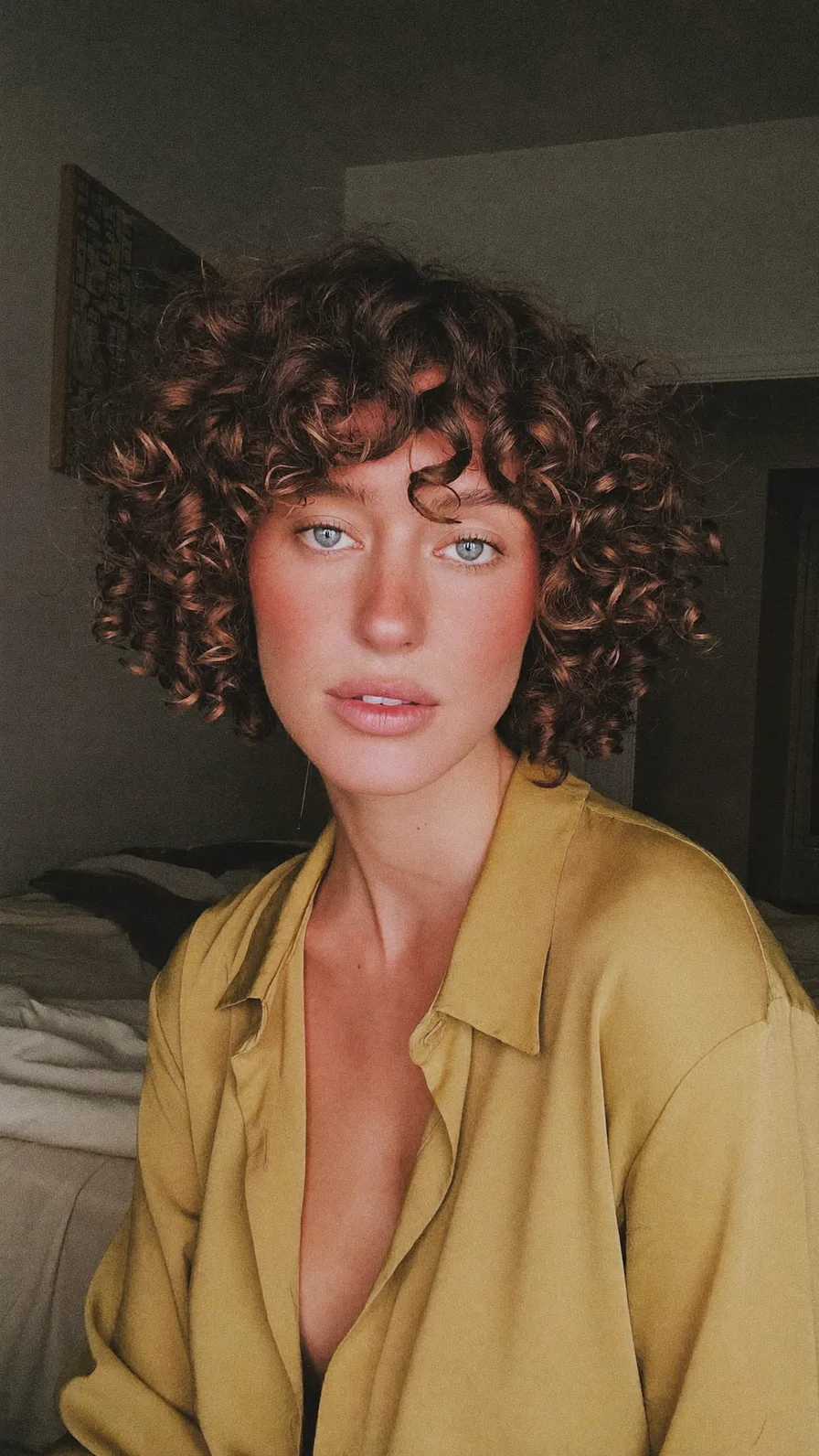 Voluminous Curly Bob with Choppy Layers and Curtain Bangs