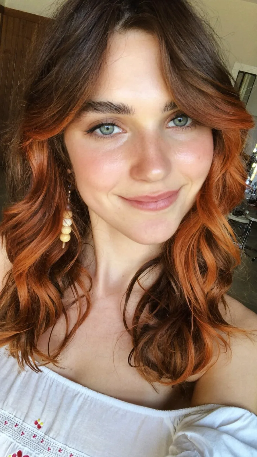 Soft Auburn Long Layered Hair with Wavy Curtain Bangs