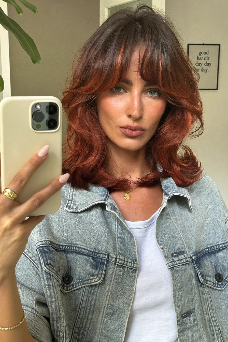 Voluminous Shoulder-Length Auburn Hair with Flicked Long Layers