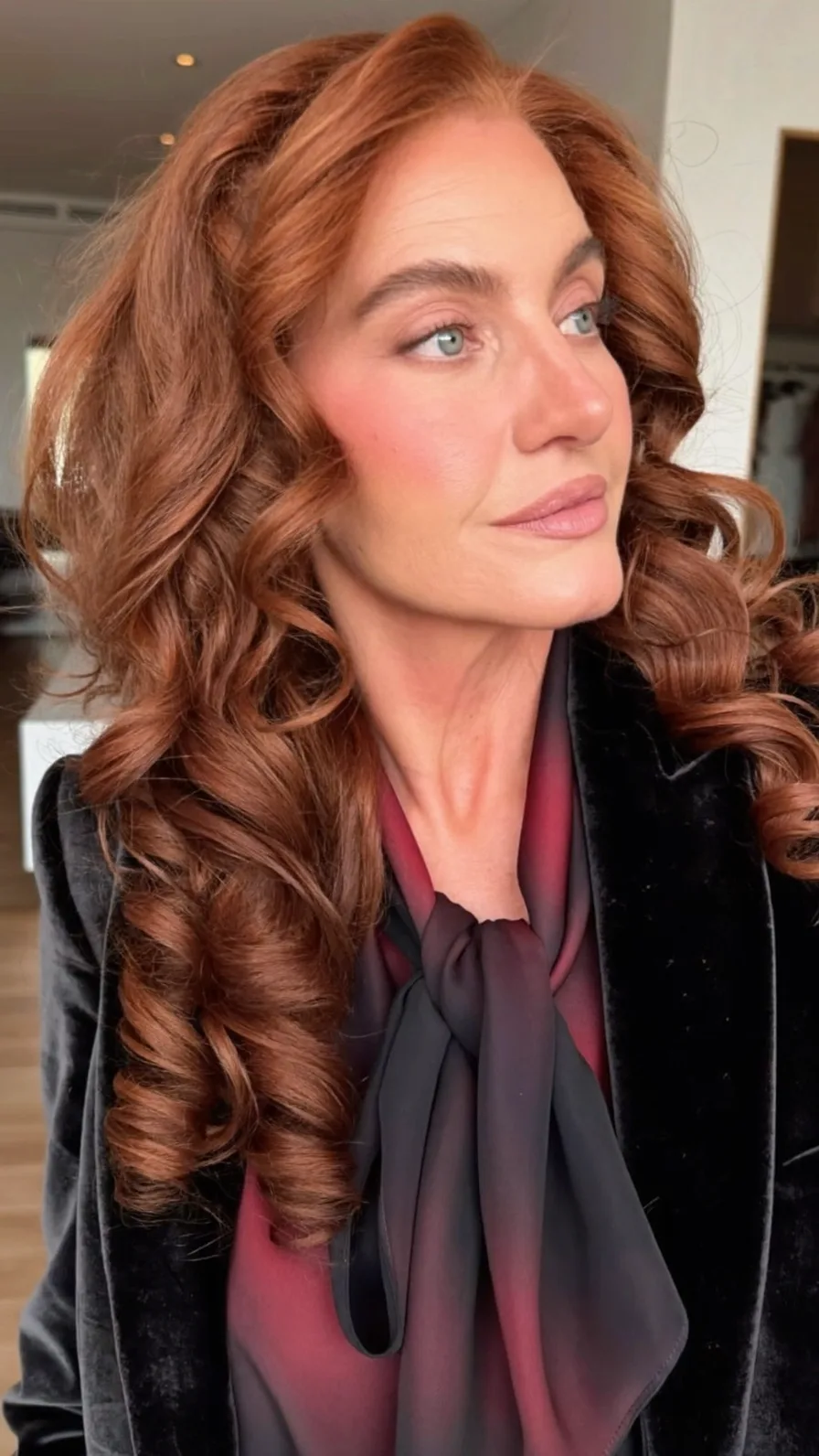 Voluminous Long Auburn Layered Hairstyle with Vintage Curls
