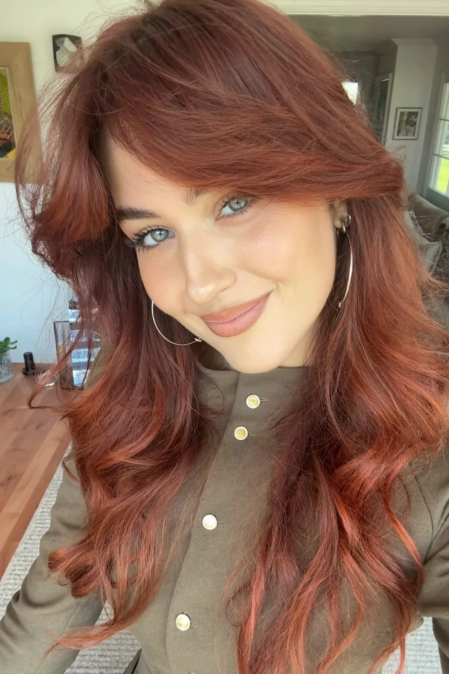 Vibrant Auburn Long Layers with Flowing Curtain Bangs