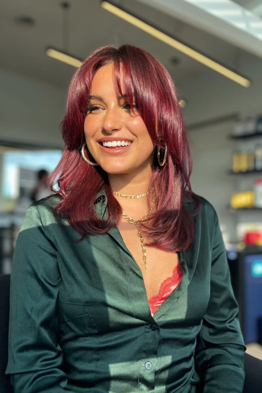 Layered Auburn Red Hair with Face-Framing Bangs for Radiant Shine