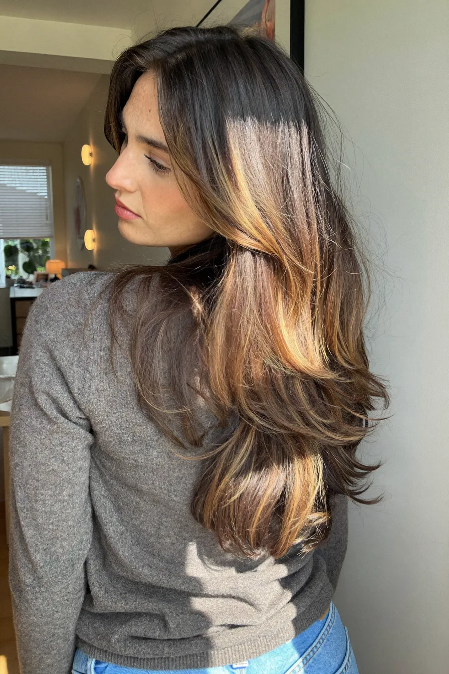 Soft Flowing Long Layers with Honey Blonde Balayage and Curtain Bangs