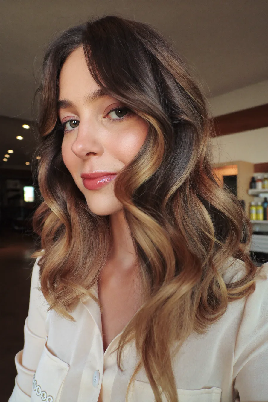 Soft Wavy Long Layers with Warm Caramel Balayage and Curtain Bangs