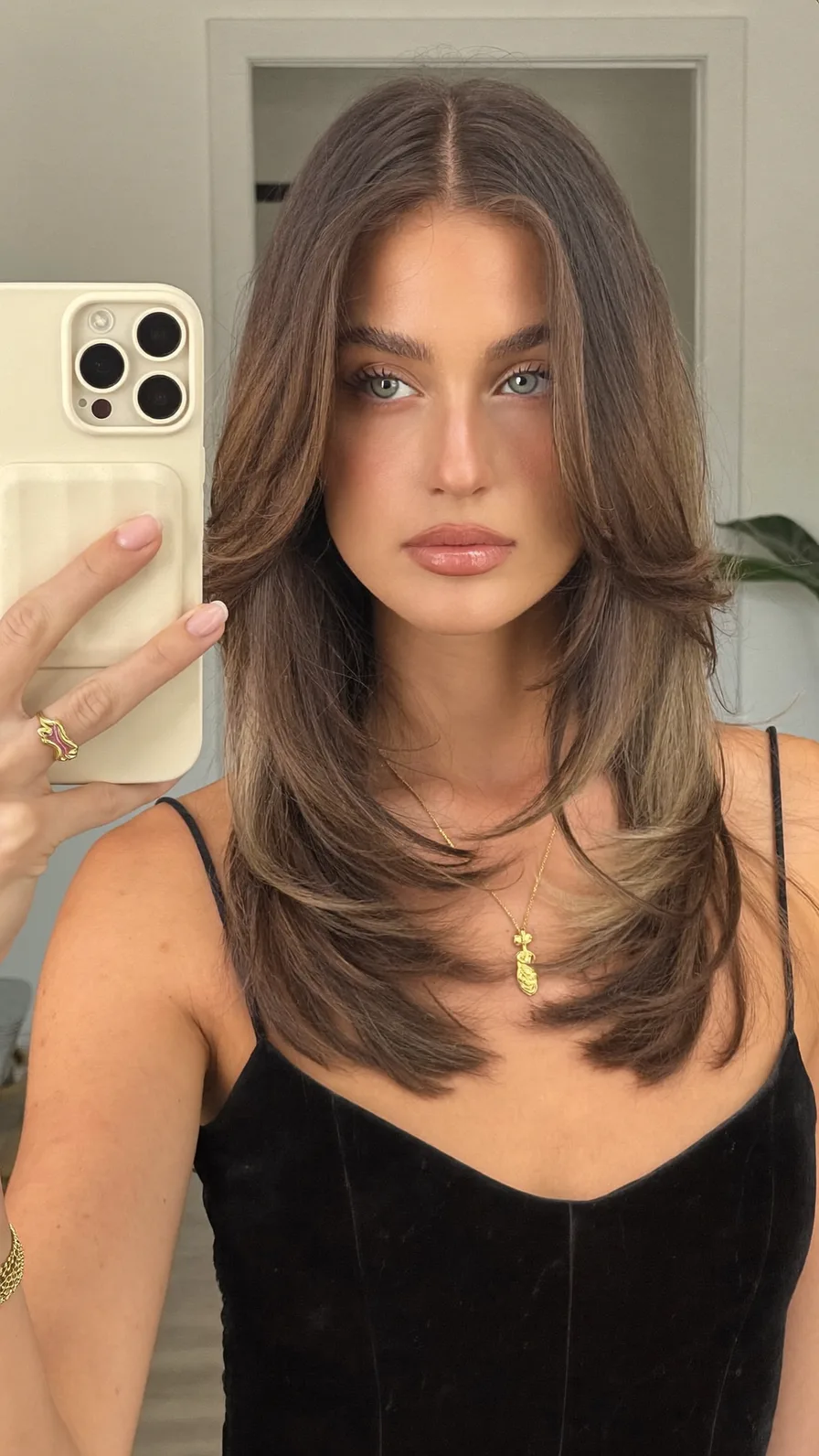Medium-Length Layered Hair with Curtain Bangs and Soft Balayage