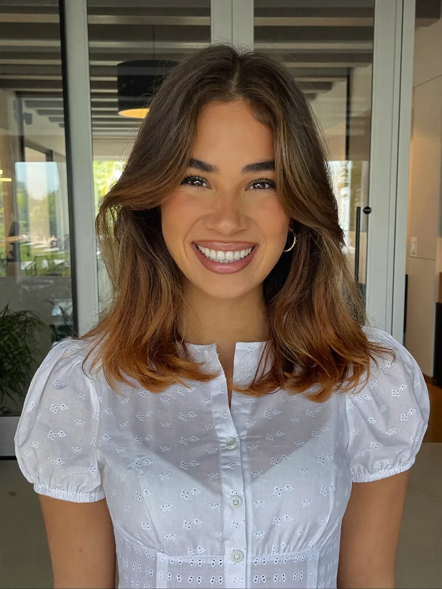 Medium-Length Layered Hair with Curtain Bangs and Balayage Highlights