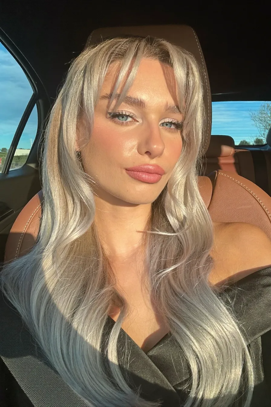 Icy Blonde Wavy Long Layered Hair with Face-Framing Bangs