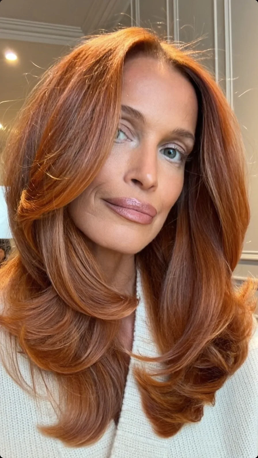 Voluminous Softly Layered Long Auburn Hair with Side-Swept Bangs