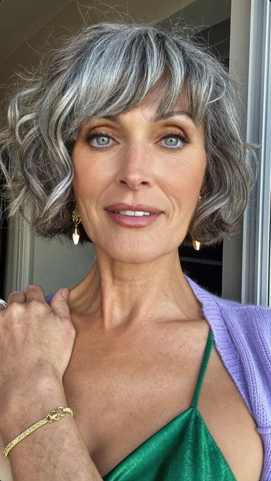 Chin-Length Textured Bob with Wispy Bangs and Natural Grey Highlights