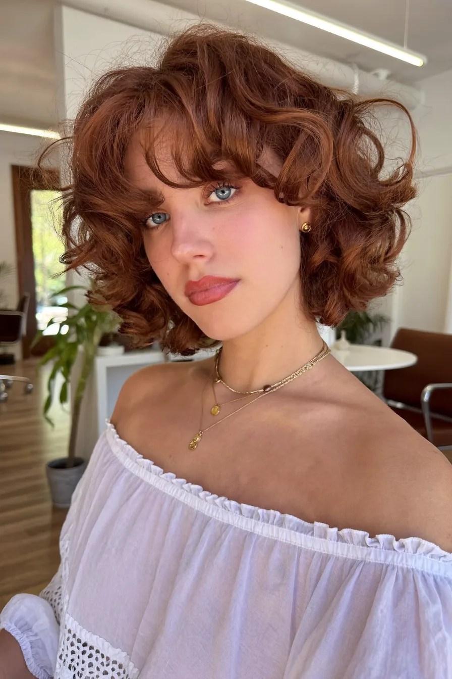 Voluminous Curly Bob in Rich Black Cherry Tones