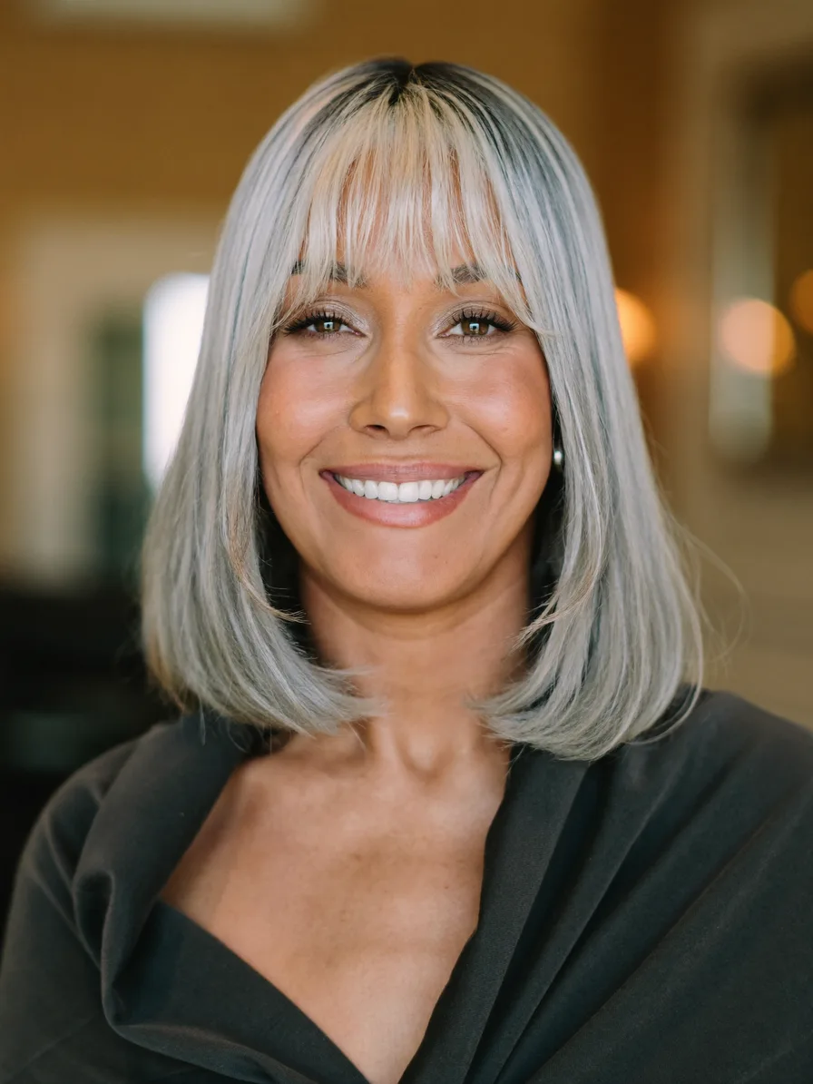 Chic shoulder-length lob with wispy curtain bangs and silver tone