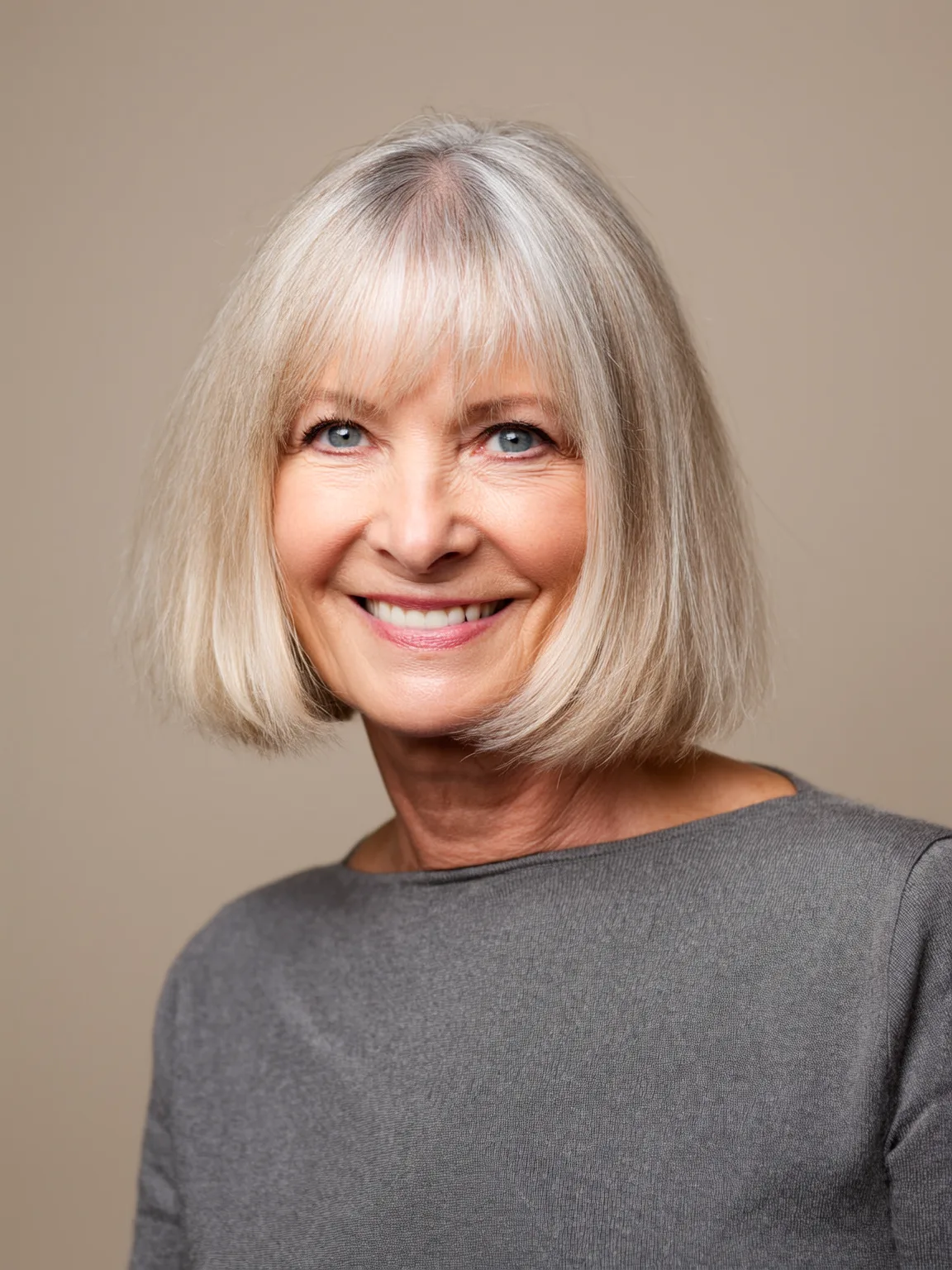 Shiny Silver Frost Bob with Defined Bangs and Blow-Dry Volume