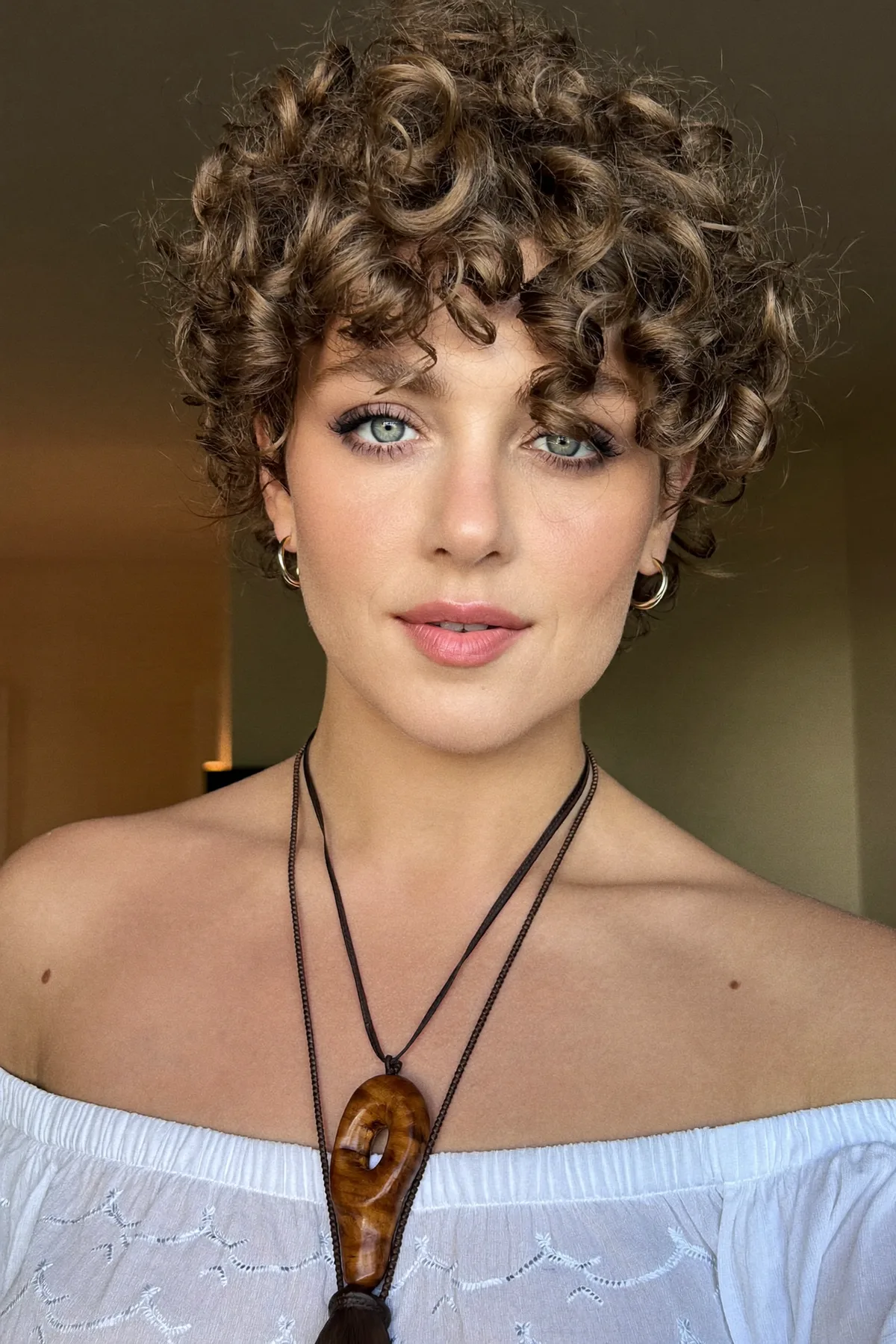 Natural Brunette Curly Pixie Cut with Full Fringe Bangs