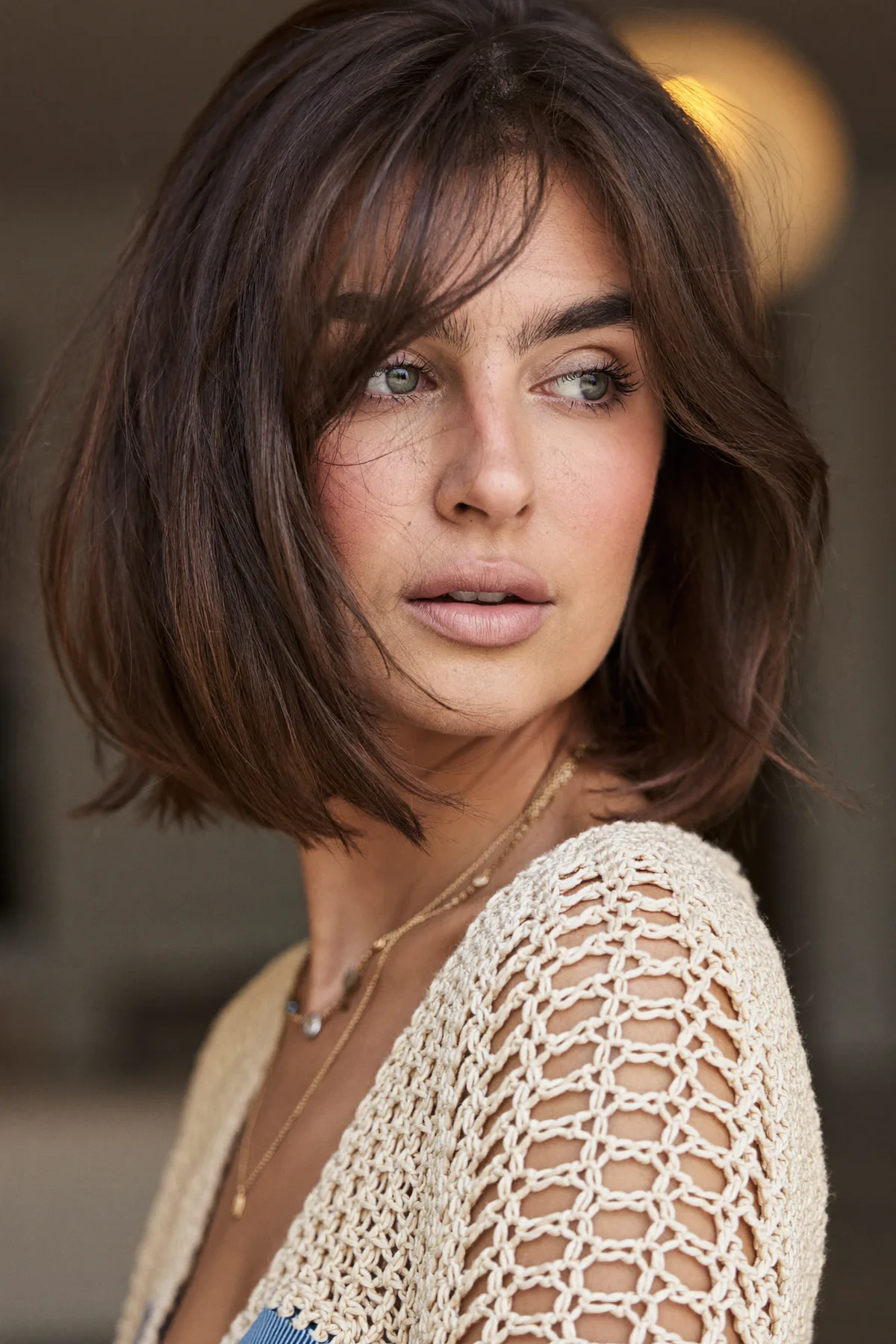 Natural Brunette Chin-Length Bob with Wavy Texture and Curtain Bangs