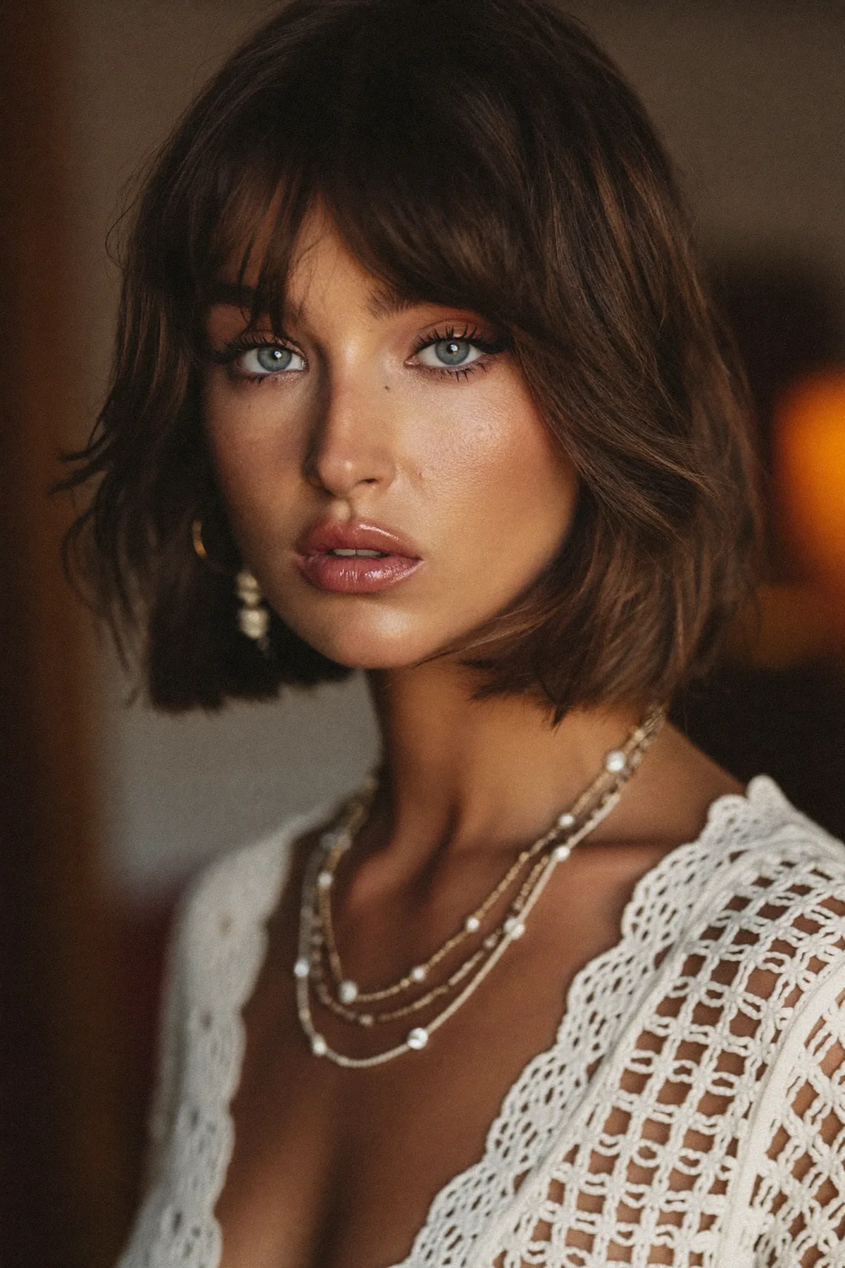 Chin-Length Natural Brunette Wavy Bob with Curtain Bangs