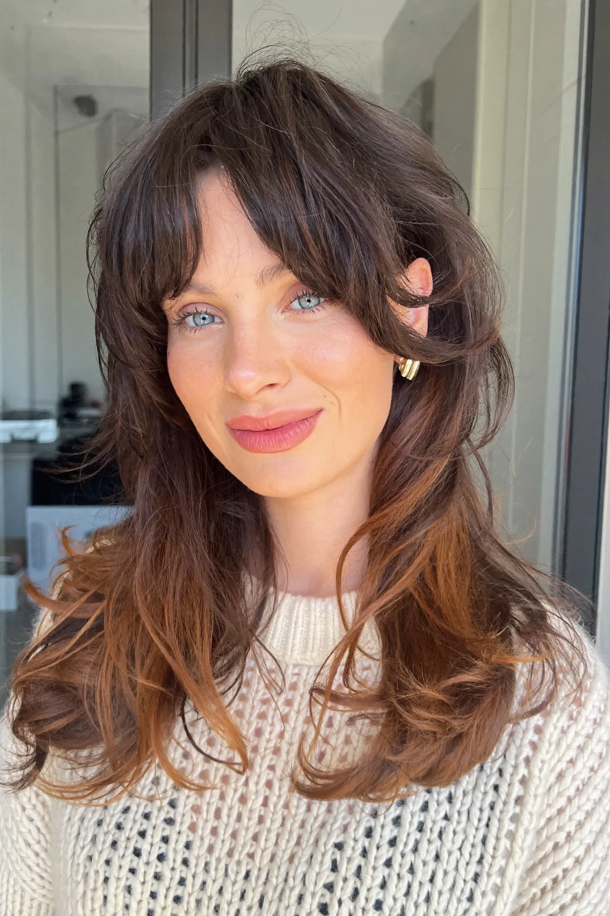 Natural Brunette Long Layered Cut With Wavy Texture and Curtain Bangs