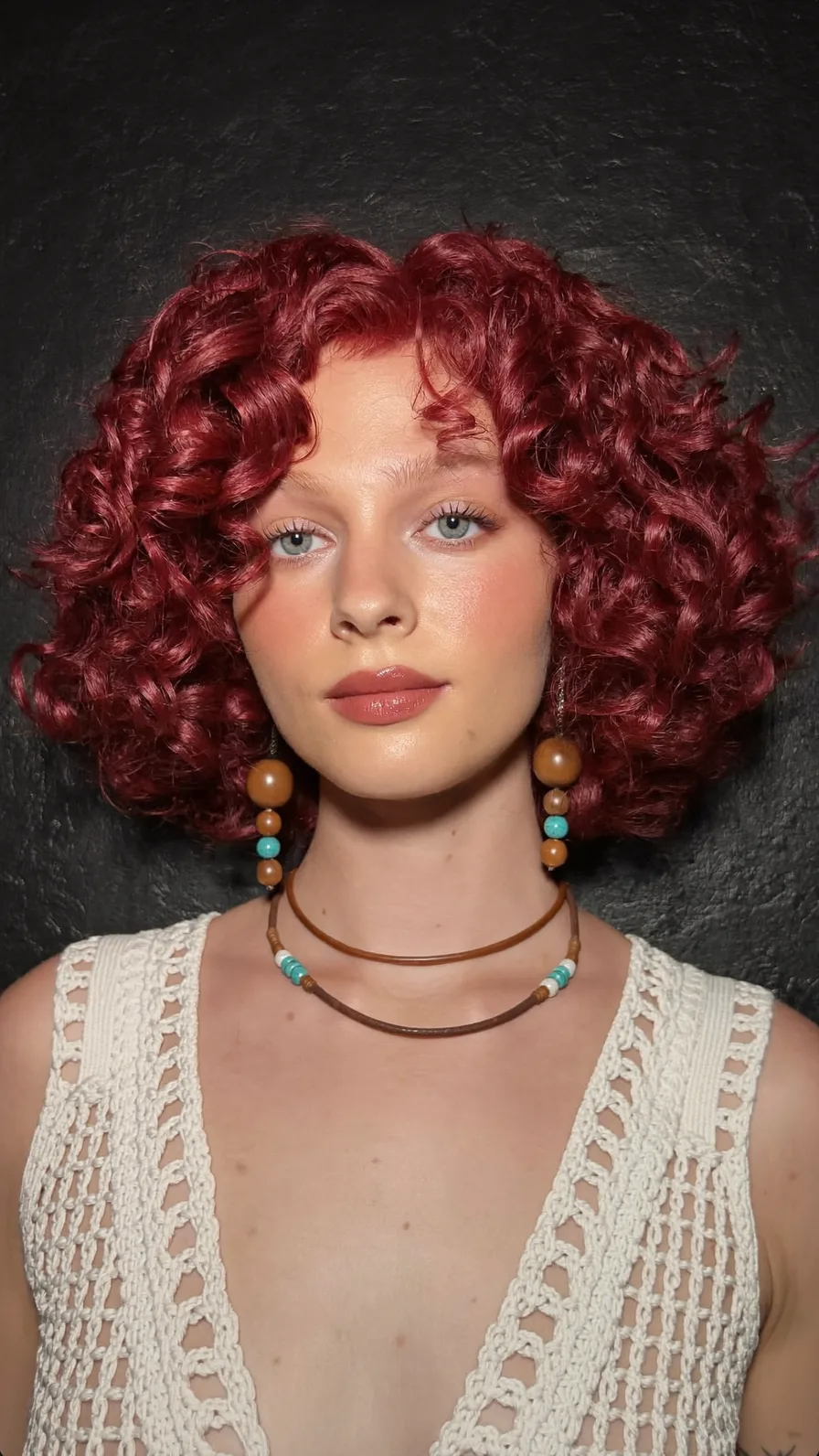 Voluminous Curly Burgundy Bob with Curtain Bangs Styling