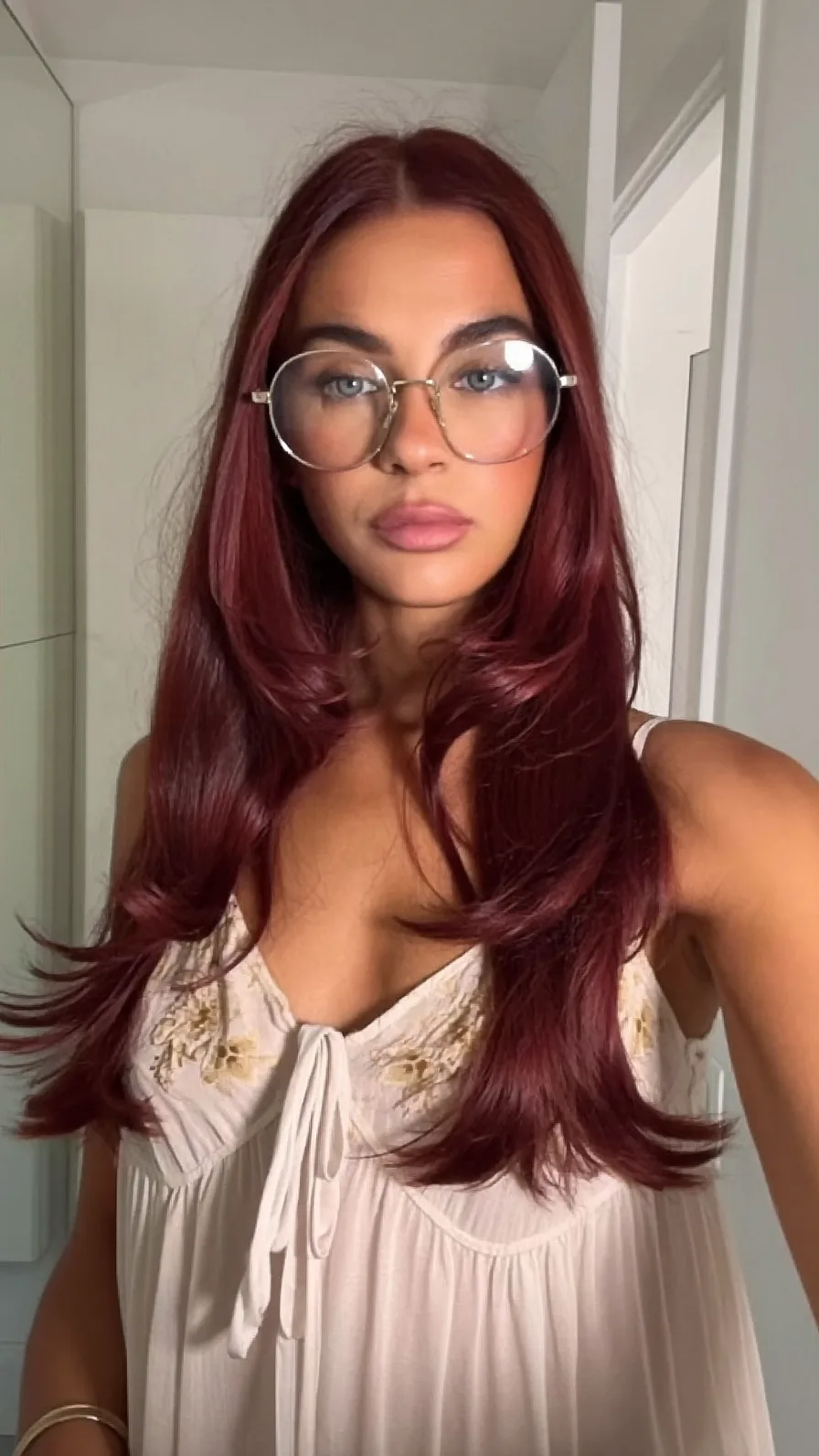 Glossy Burgundy Long Layered Hairstyle with Flicked Ends