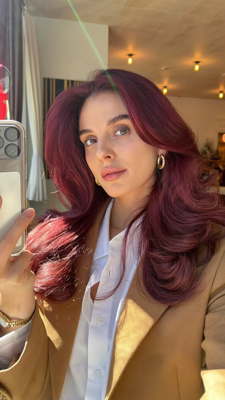 Voluminous Long Layered Burgundy Hairstyle with Curtain Bangs