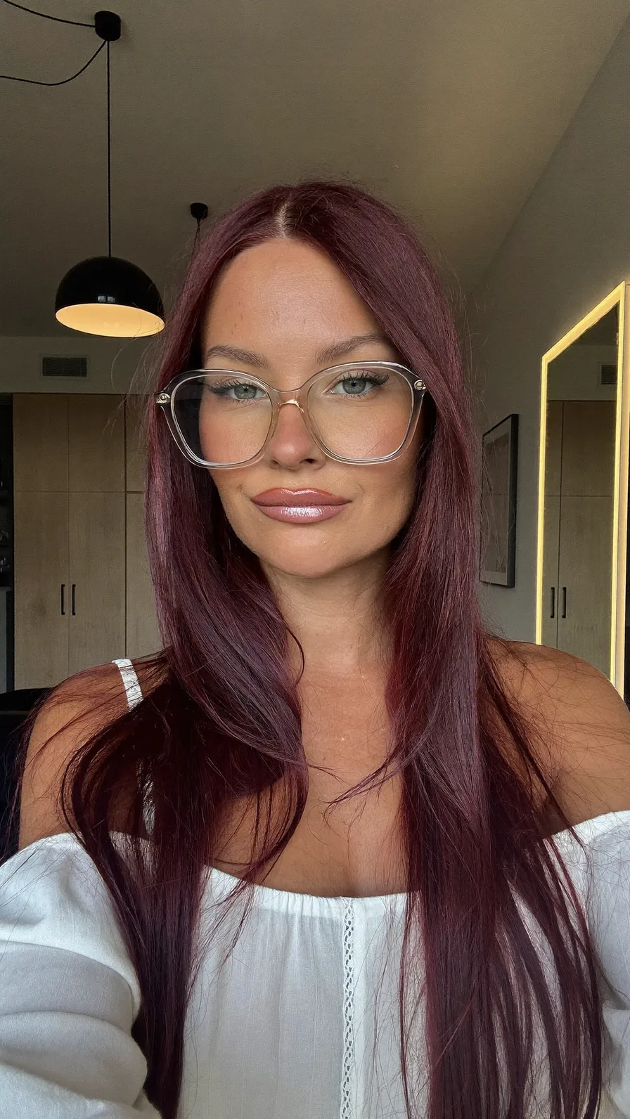Sleek Long Burgundy Layers with Center Part and Glasses