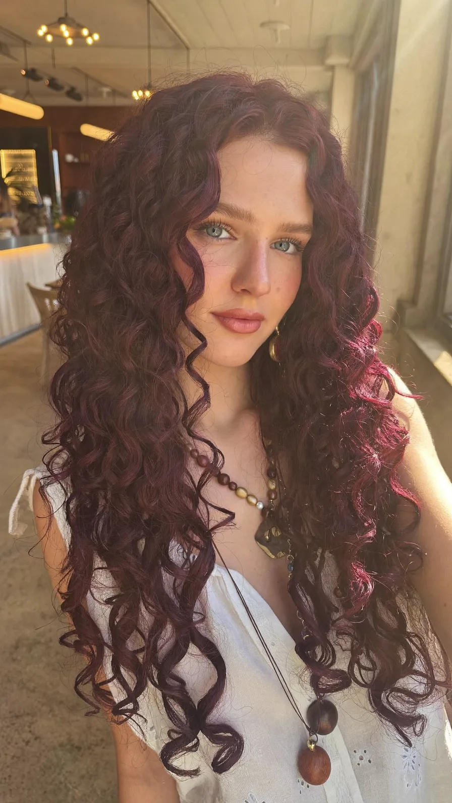 Voluminous Deep Burgundy Curls with Long Layered Cut