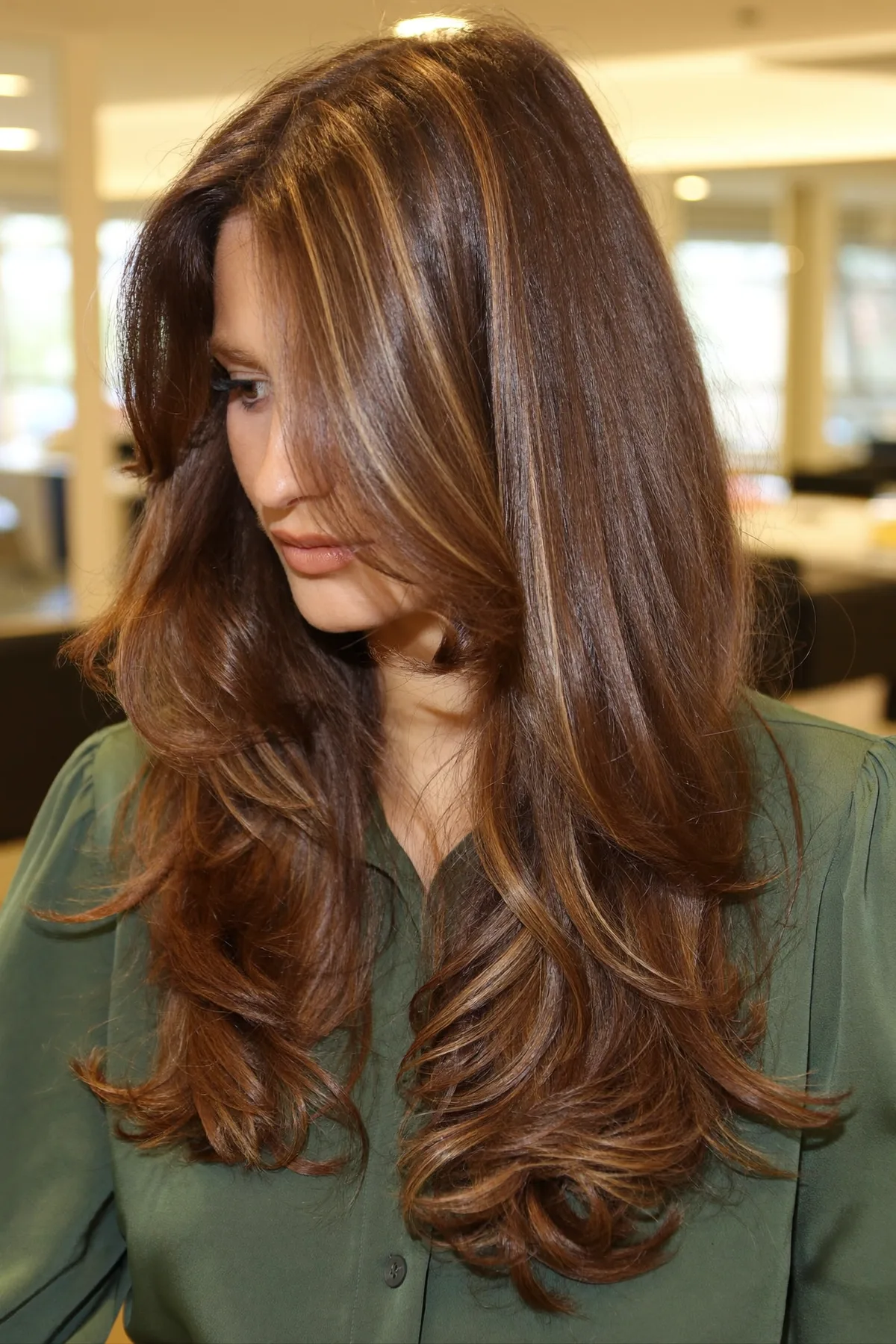 Caramel Bronde Balayage on Long Layered Mid-Back Wavy Cut with Curtain Bangs