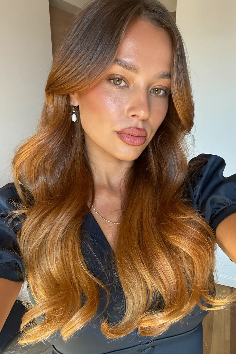 Warm Caramel Brown Long Layers with Flowing Curtain Bangs