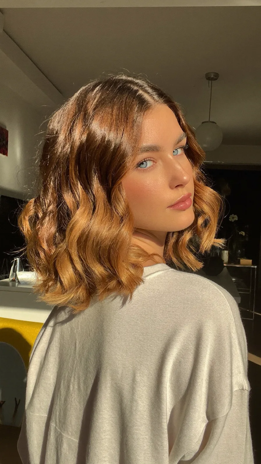 Wavy Shoulder-Length Caramel Balayage with Curtain Bangs