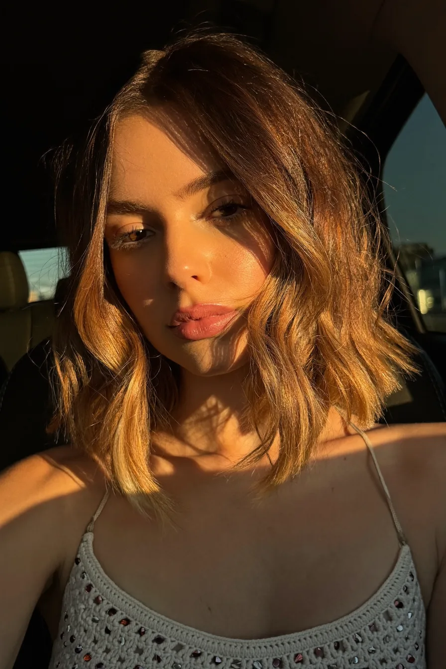 Soft Wavy Lob with Warm Caramel Balayage and Curtain Bangs
