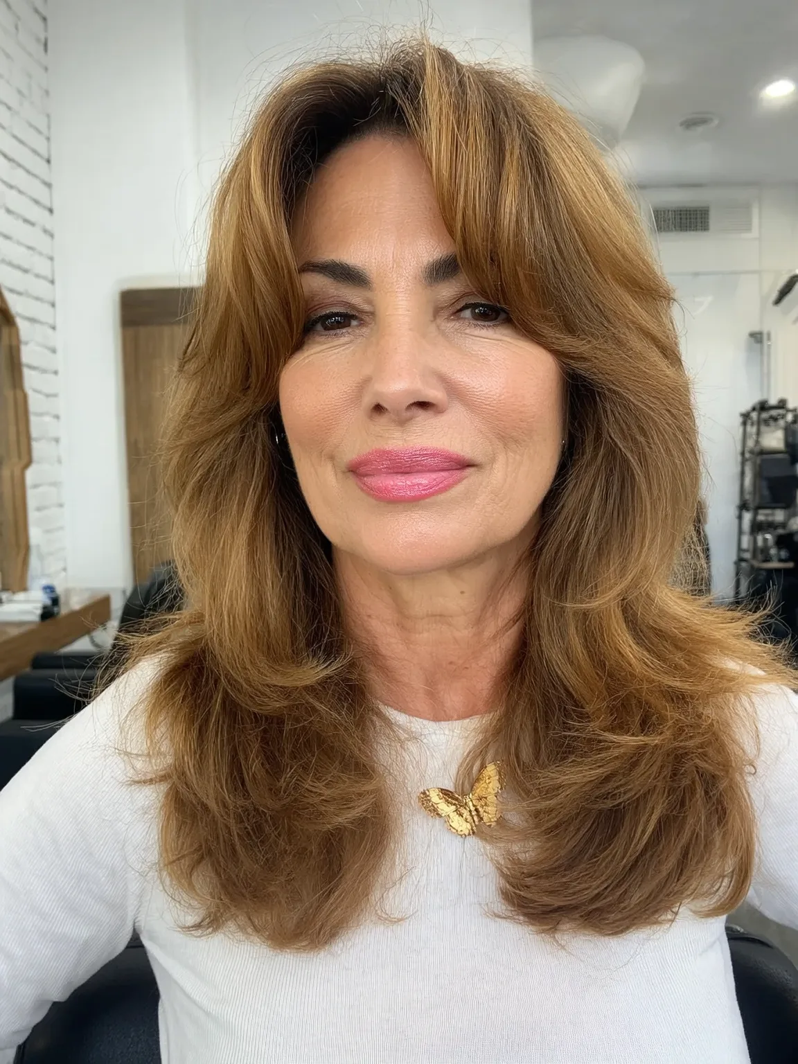 Long Wavy Layers with Curtain Bangs and Warm Caramel Glow