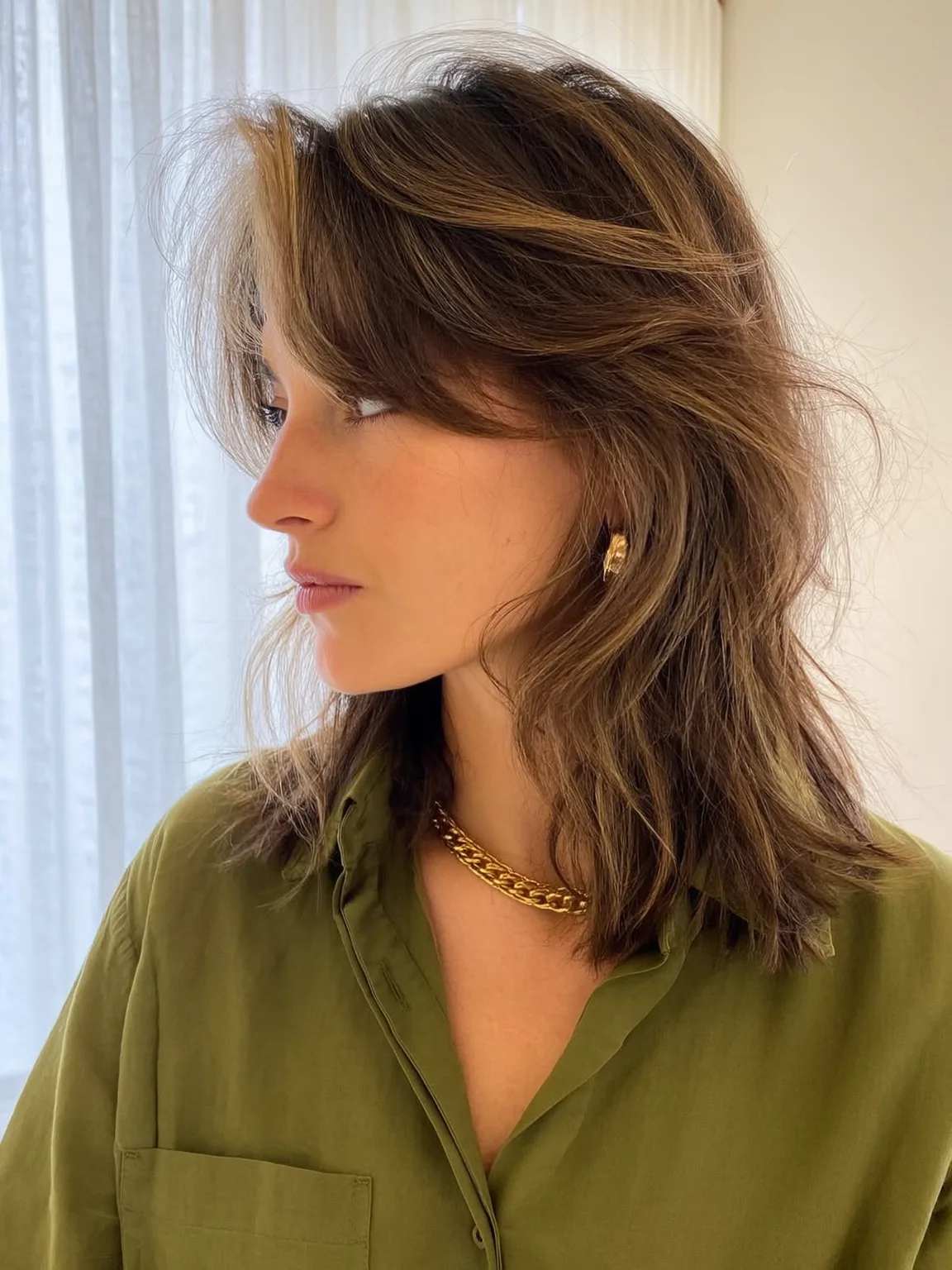Textured Shoulder-Length Shag with Golden Highlights