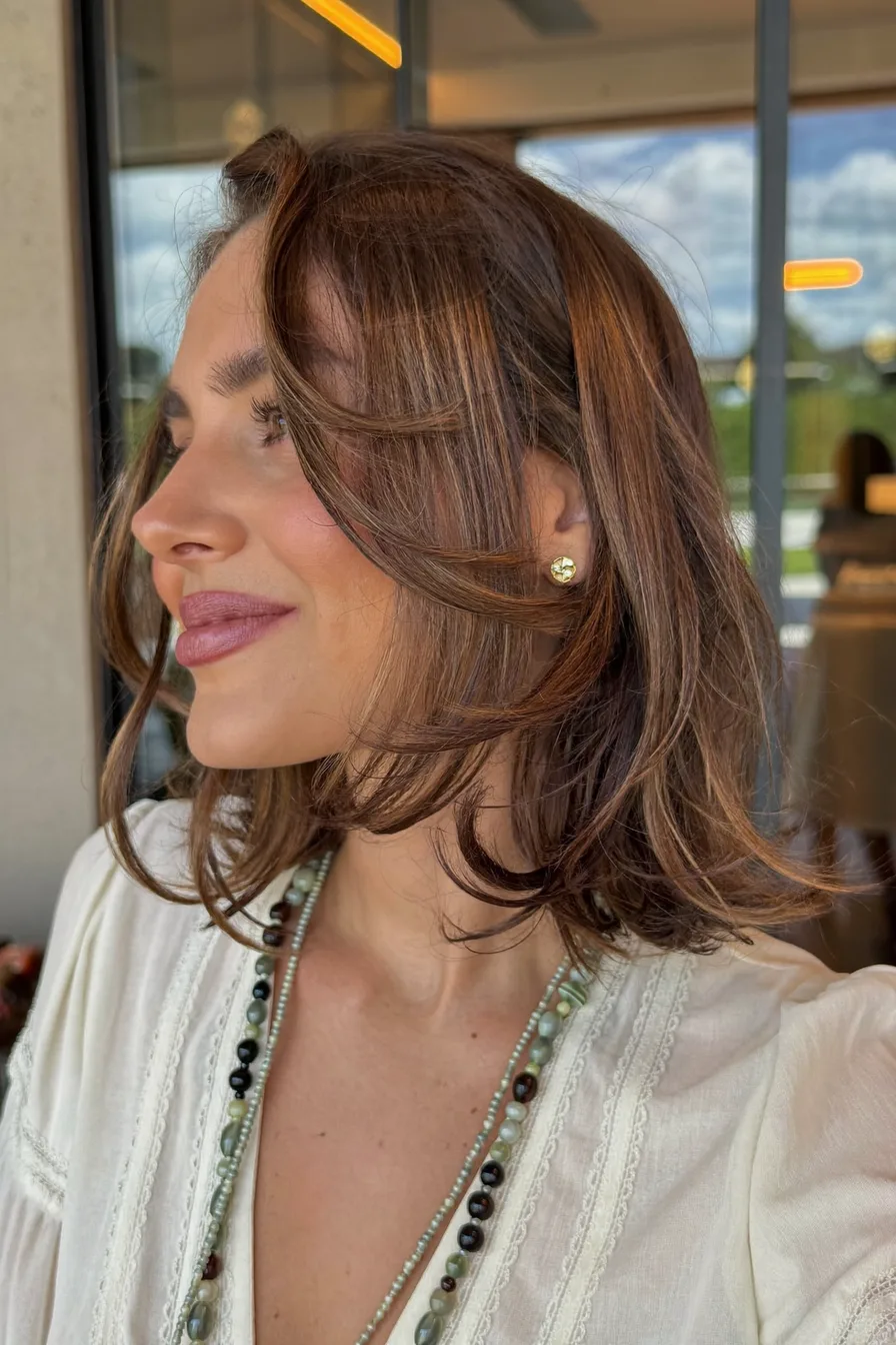 Voluminous Chestnut Wavy Lob with Feathered Curtain Bangs