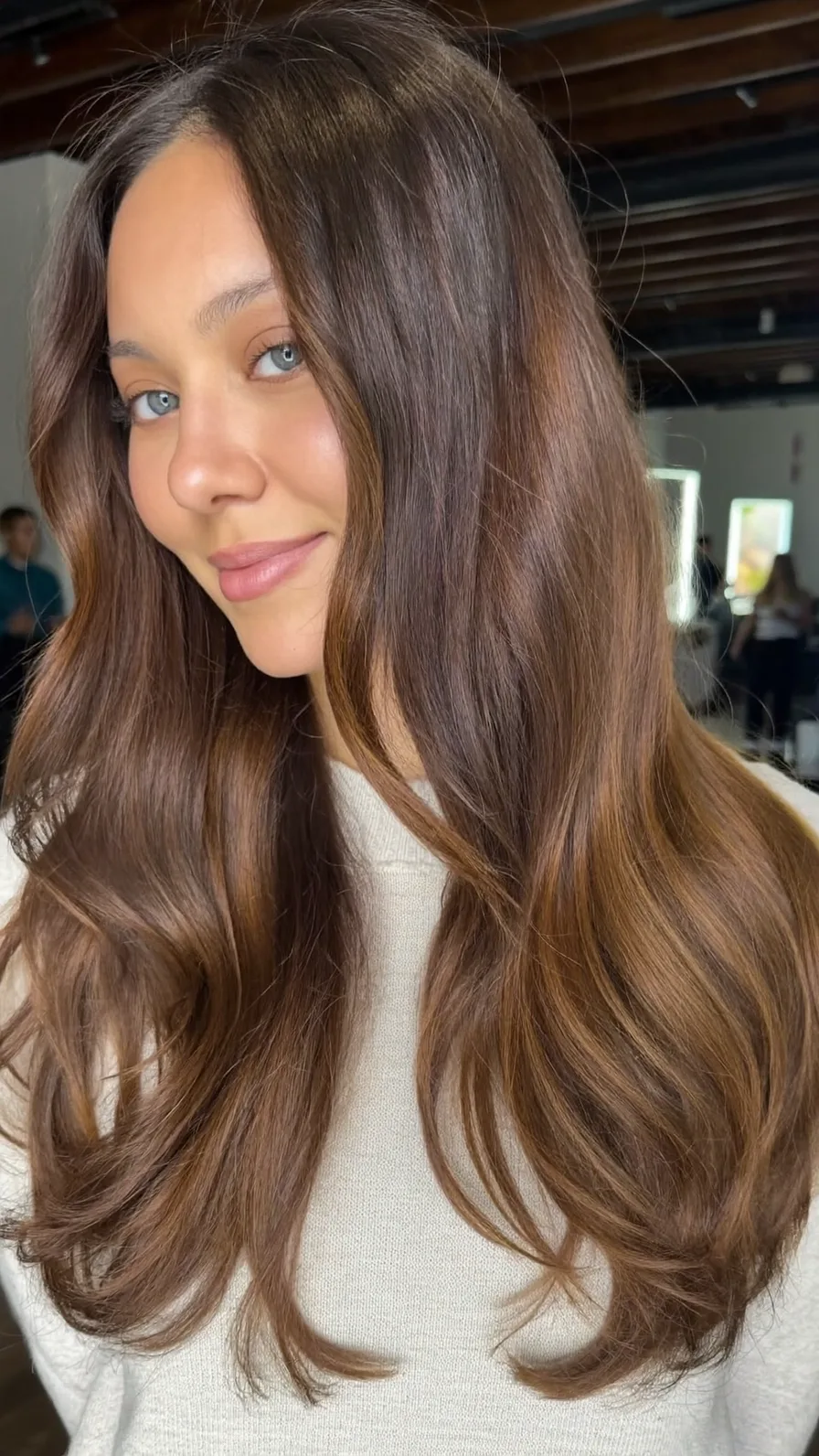 Soft Long Layered Waves with Curtain Bangs and Warm Balayage Highlights