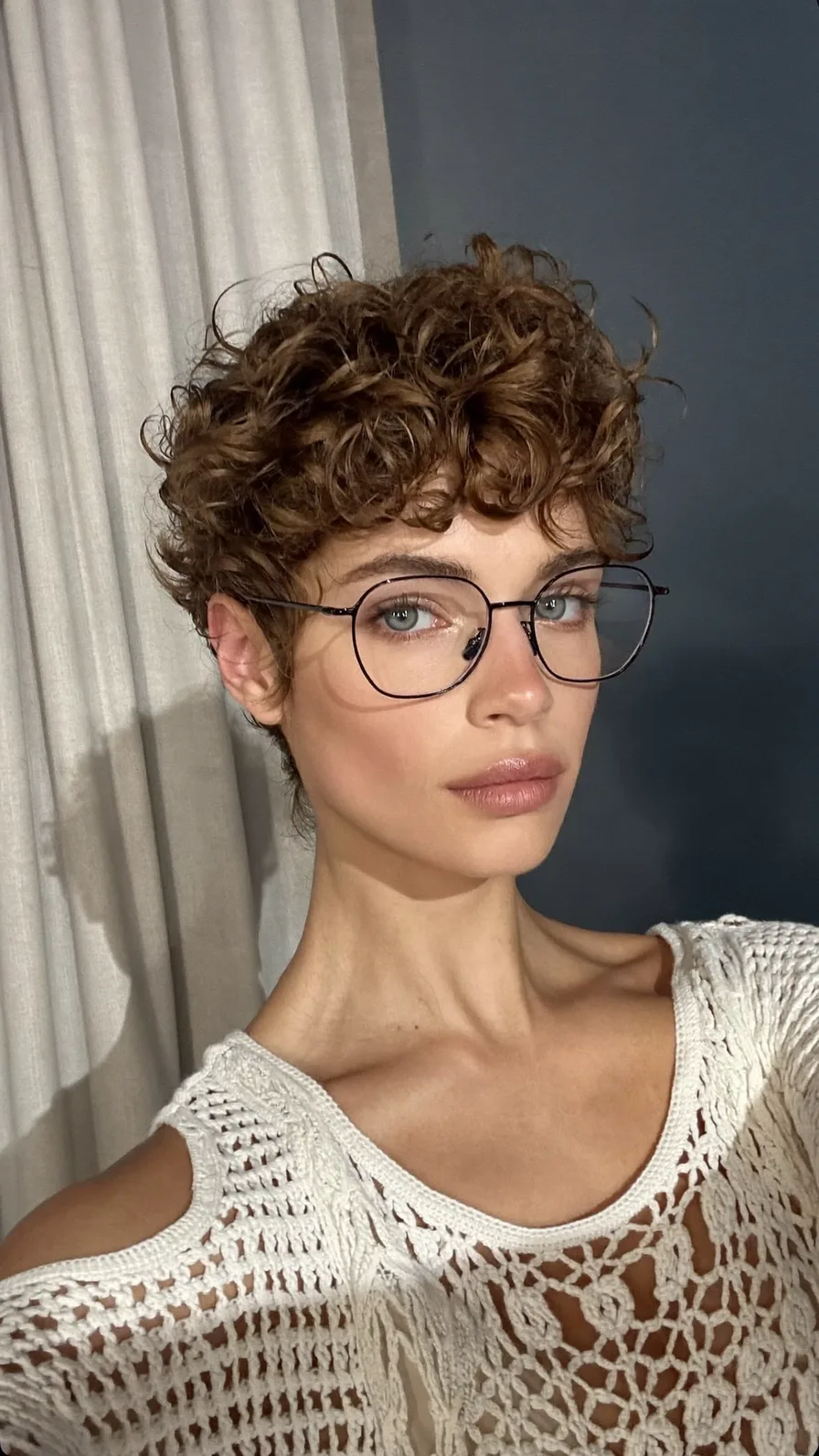 Voluminous Curly Pixie with Soft Curtain Bangs for Oval Faces