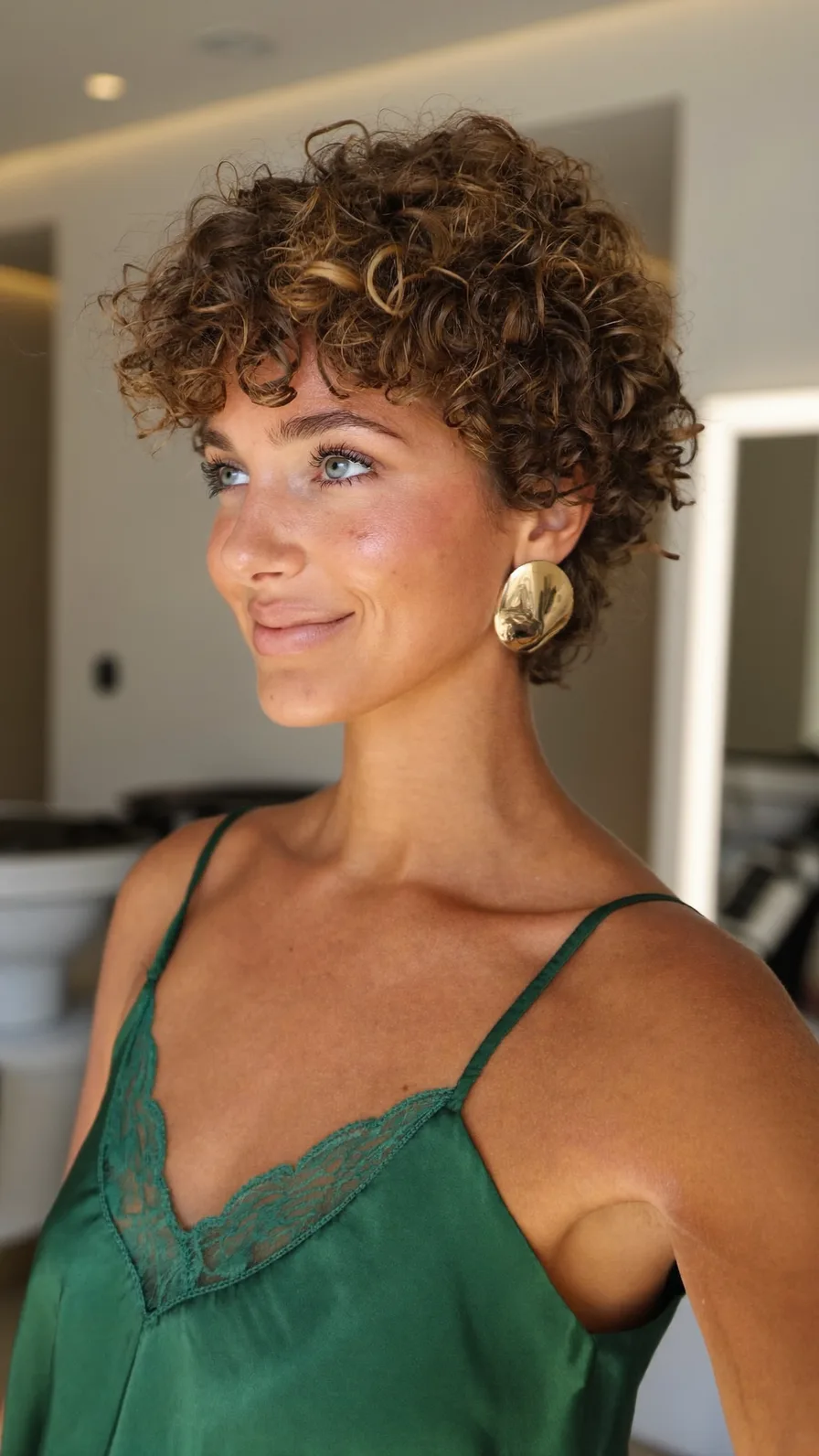 Short Voluminous Curly Pixie with Curtain Bangs and Highlights