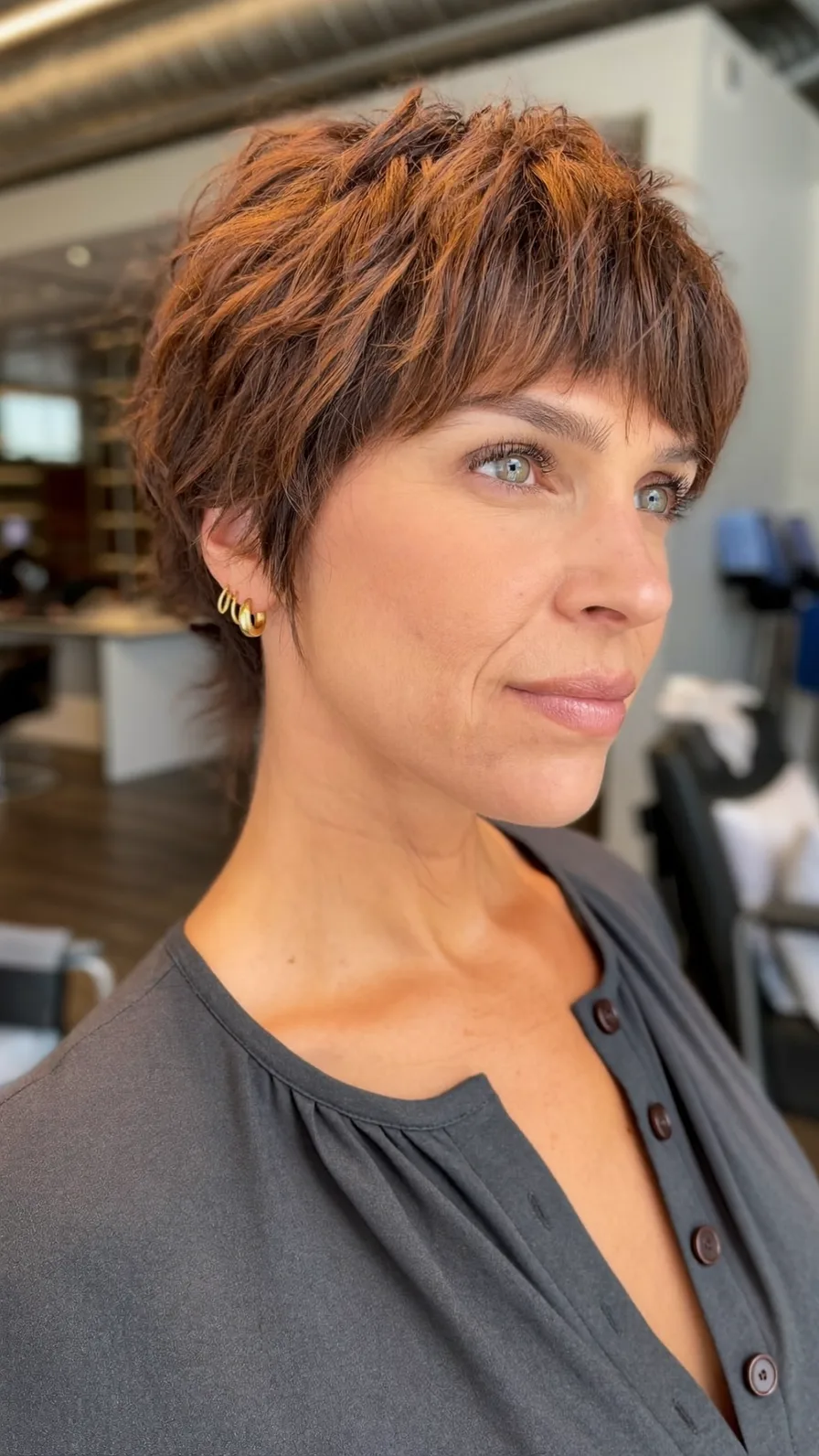 Voluminous Textured Pixie with Blunt Bangs and Subtle Highlights