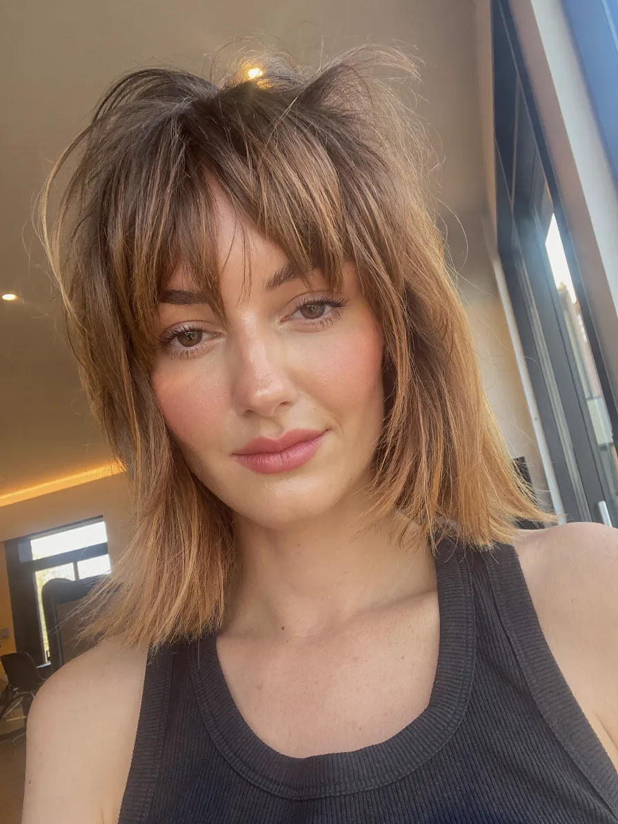 Voluminous Textured Shag with Curtain Bangs and Balayage Highlights